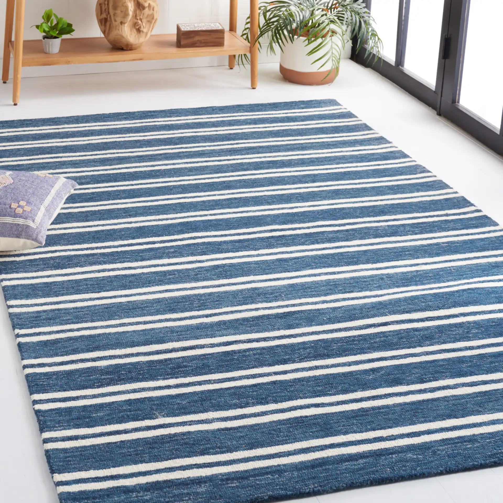 Metro Stripe Hand-Tufted Rug in Blue / Ivory in a styled room