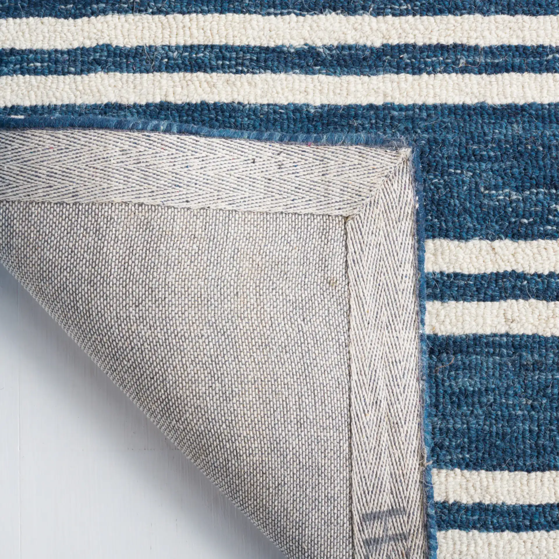 Metro Stripe Hand-Tufted Rug in Blue / Ivory in a styled room