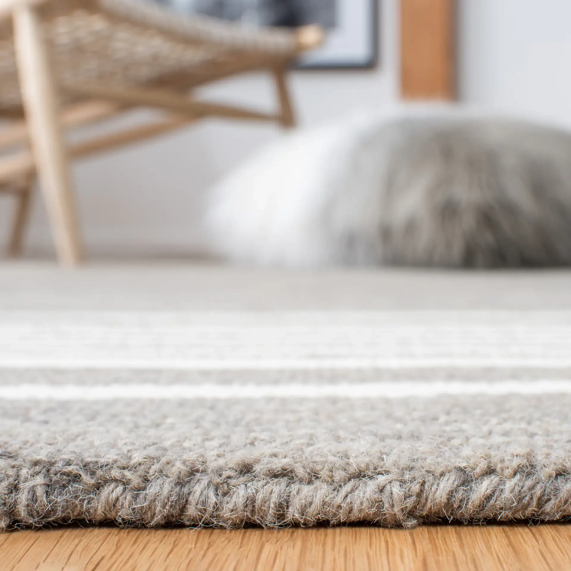 Metro Striped Border Hand-Tufted Wool Rug in Charcoal / Ivory in a styled room