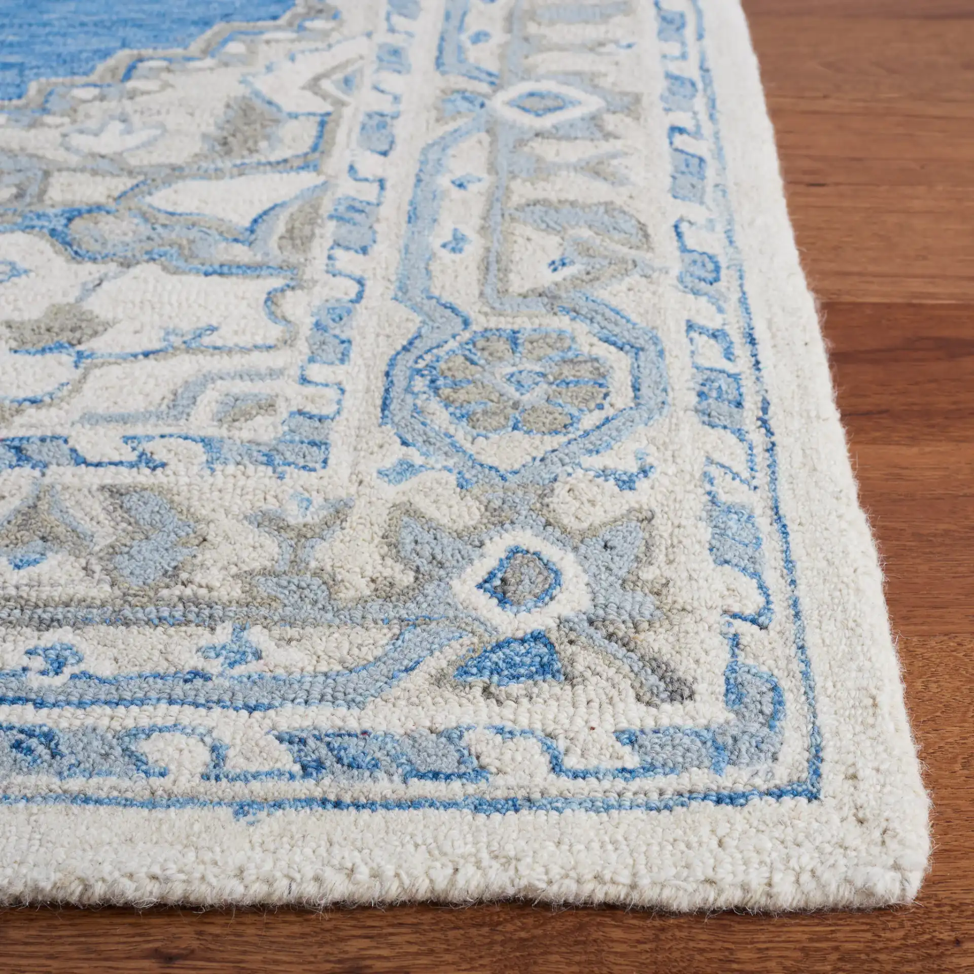 Metro Stepped Medallion Hand-Tufted Wool Rug in Navy / Ivory in a styled room