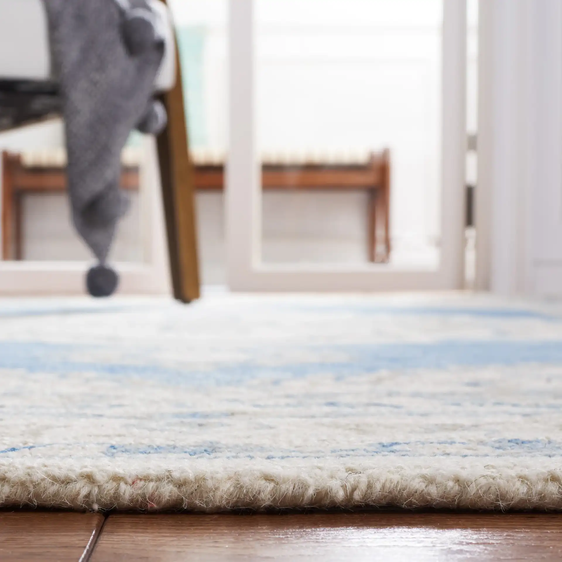 Metro Stepped Medallion Hand-Tufted Wool Rug in Navy / Ivory in a styled room