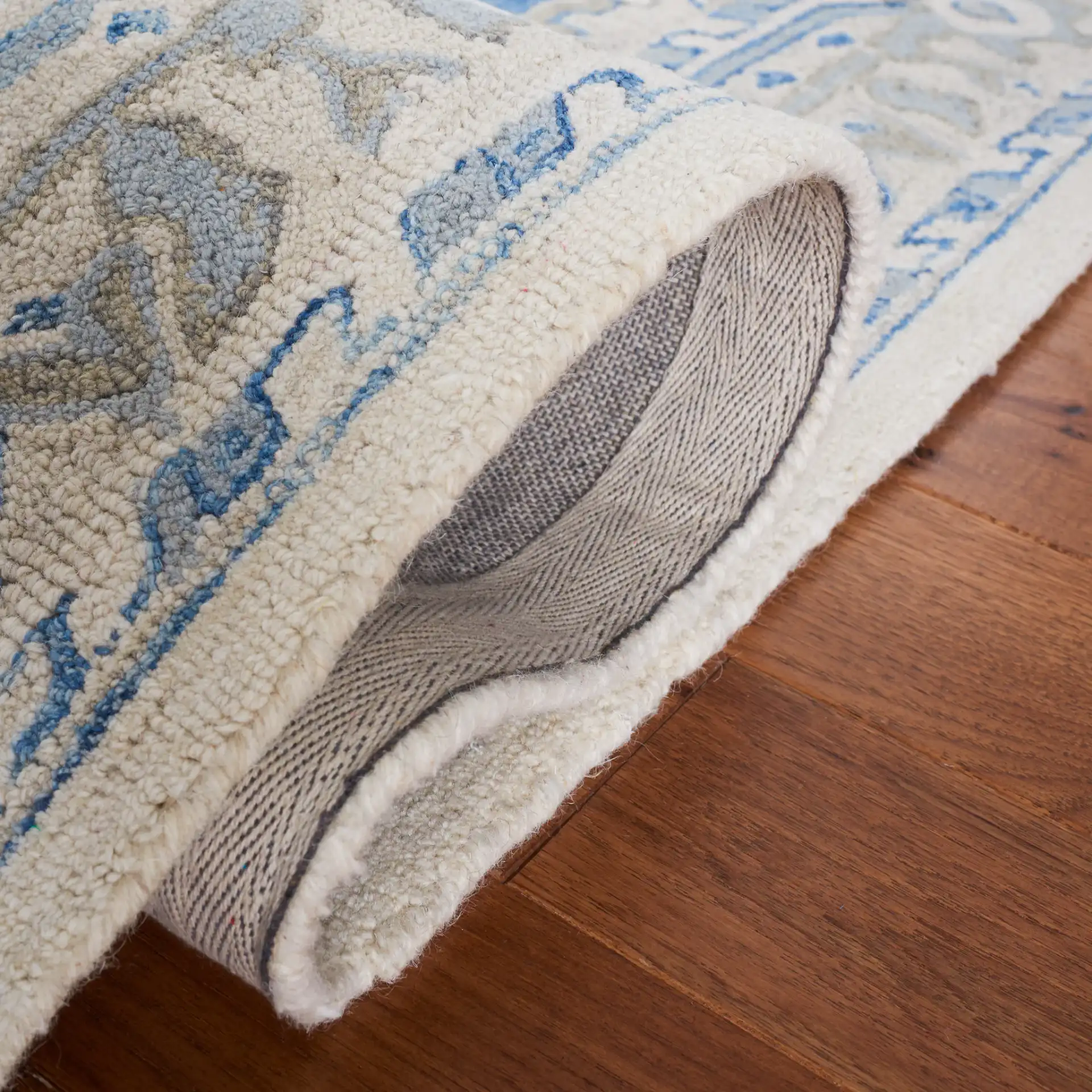 Metro Stepped Medallion Hand-Tufted Wool Rug in Navy / Ivory in a styled room
