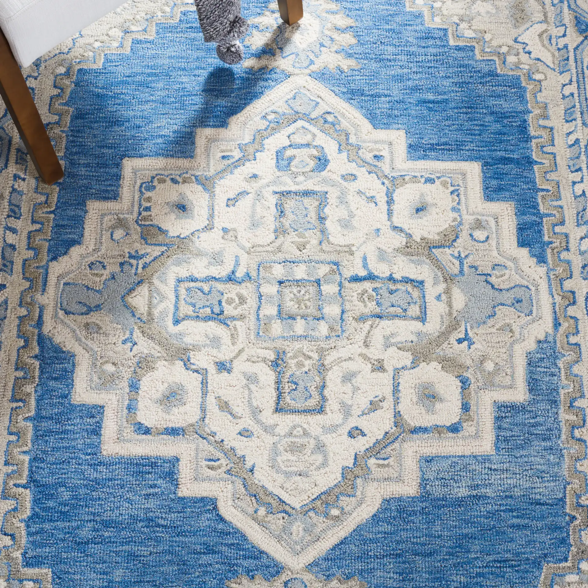 Metro Stepped Medallion Hand-Tufted Wool Rug in Navy / Ivory in a styled room