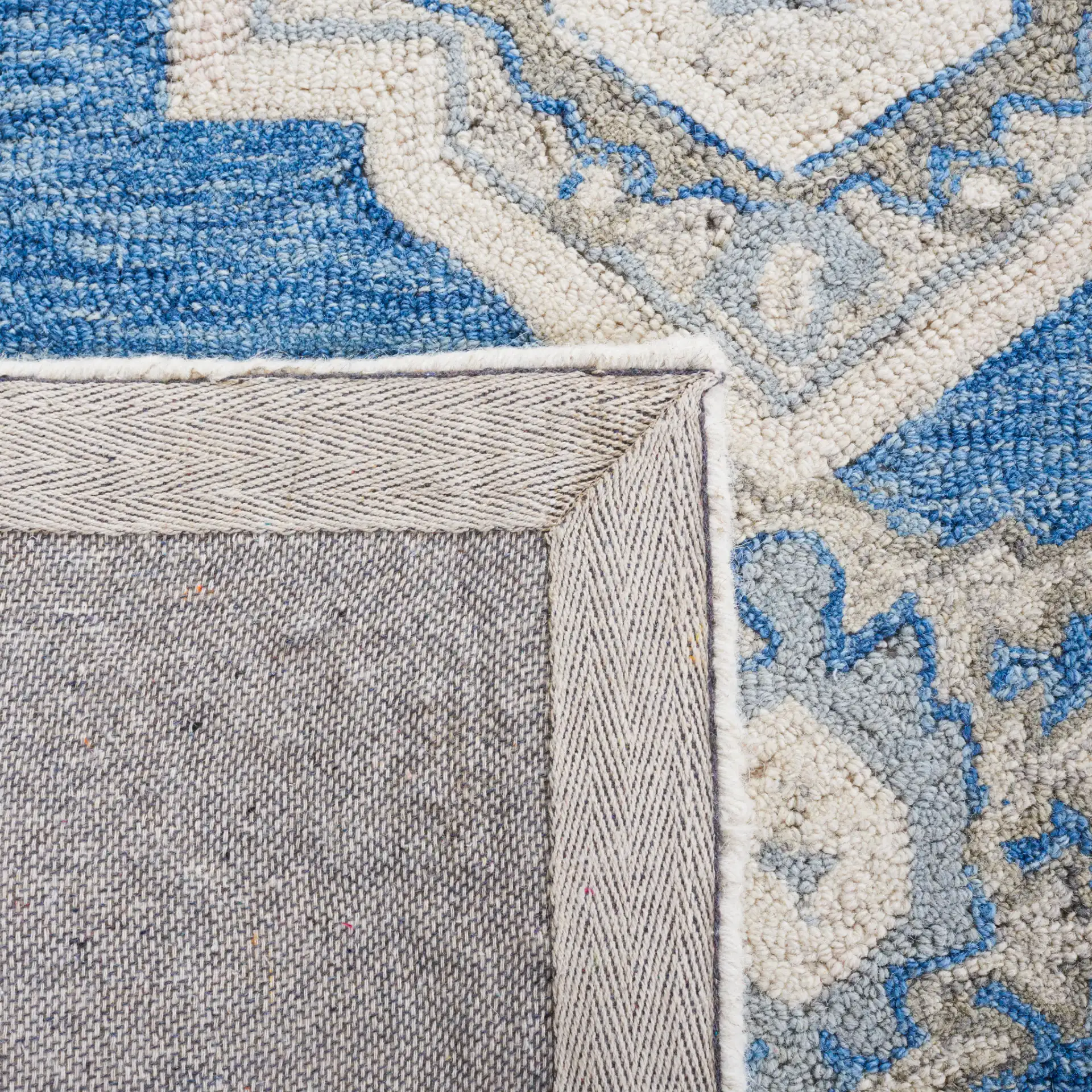 Metro Stepped Medallion Hand-Tufted Wool Rug in Navy / Ivory in a styled room