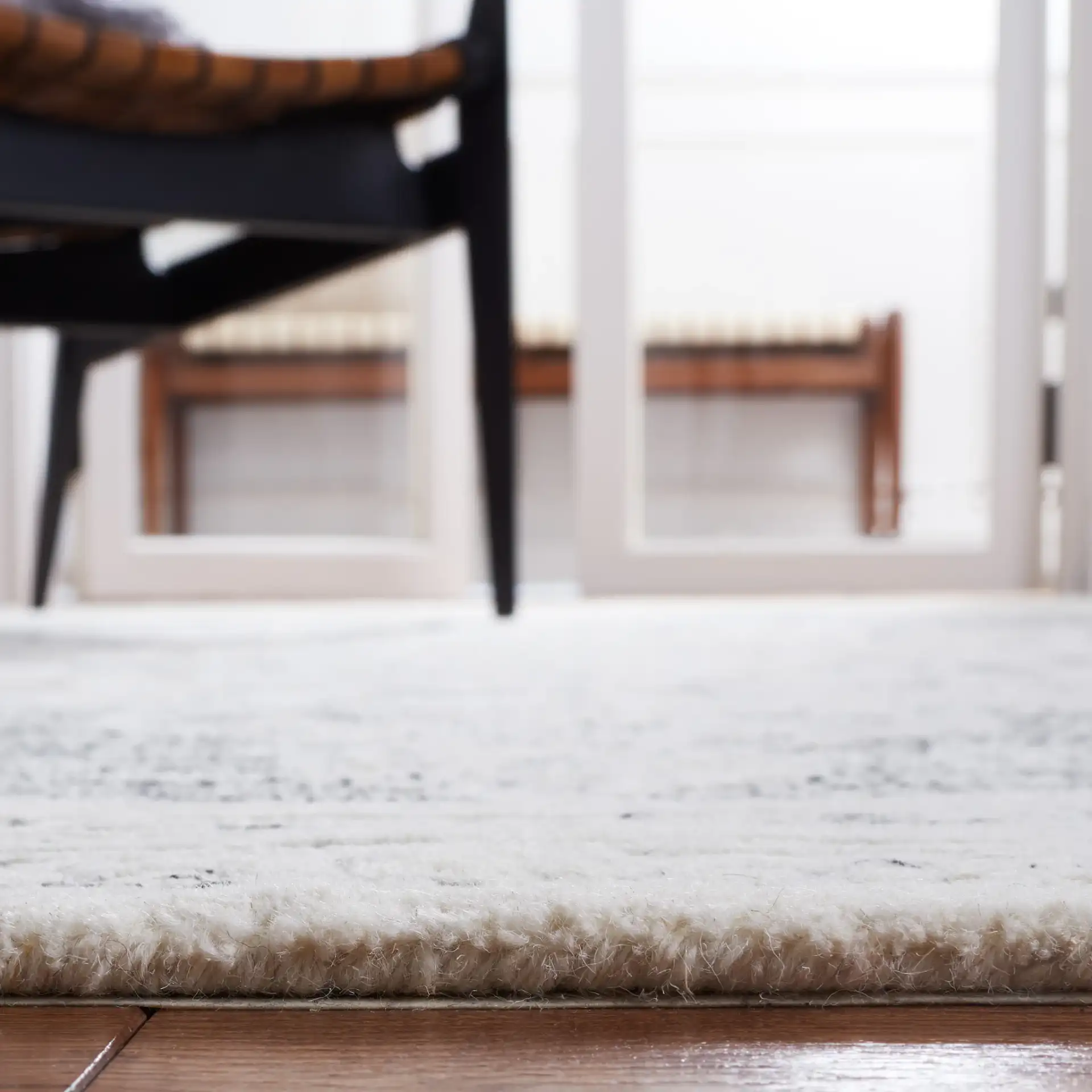 Metro Scroll Medallion Hand-Tufted Wool Rug in Ivory / Black in a styled room