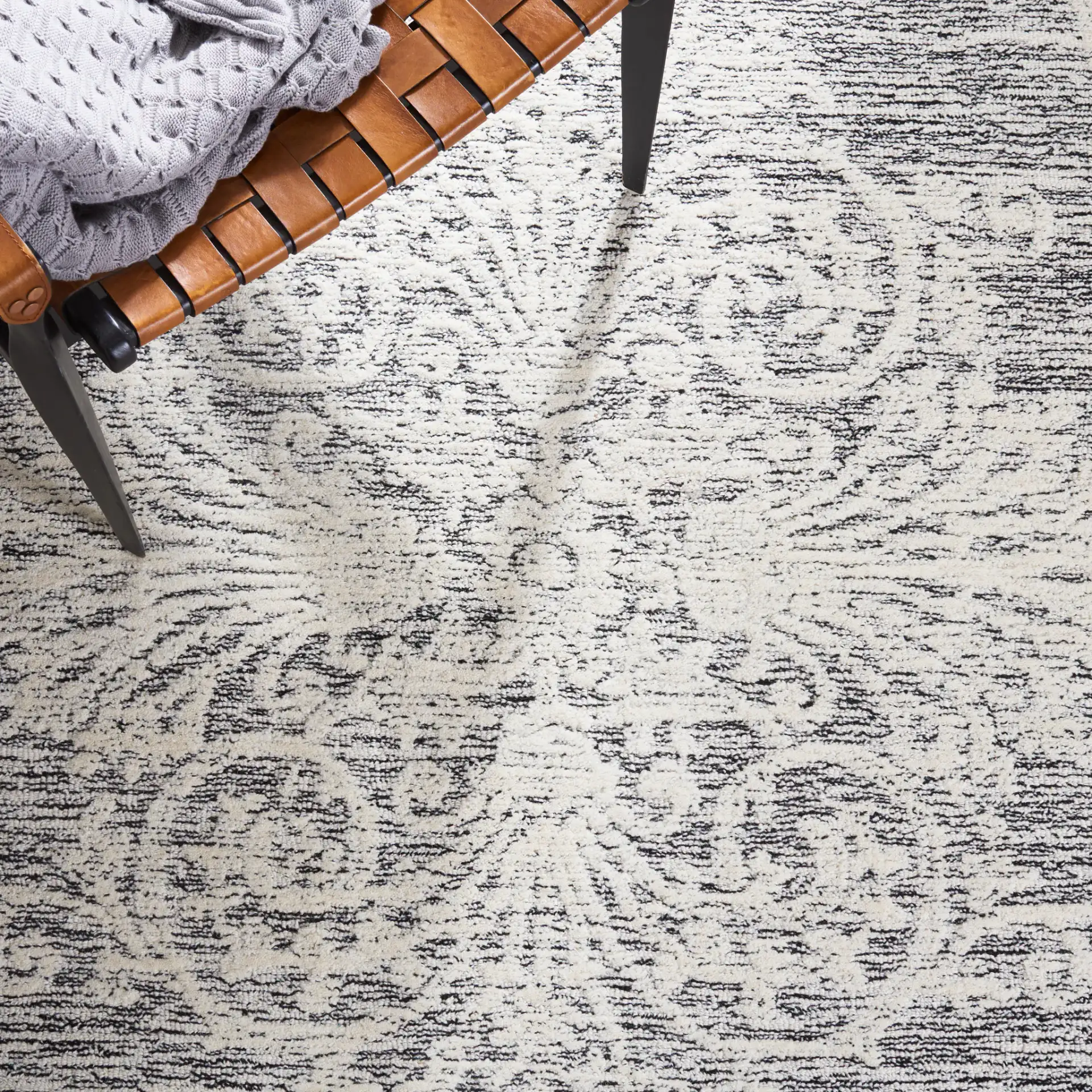 Metro Scroll Medallion Hand-Tufted Wool Rug in Ivory / Black in a styled room