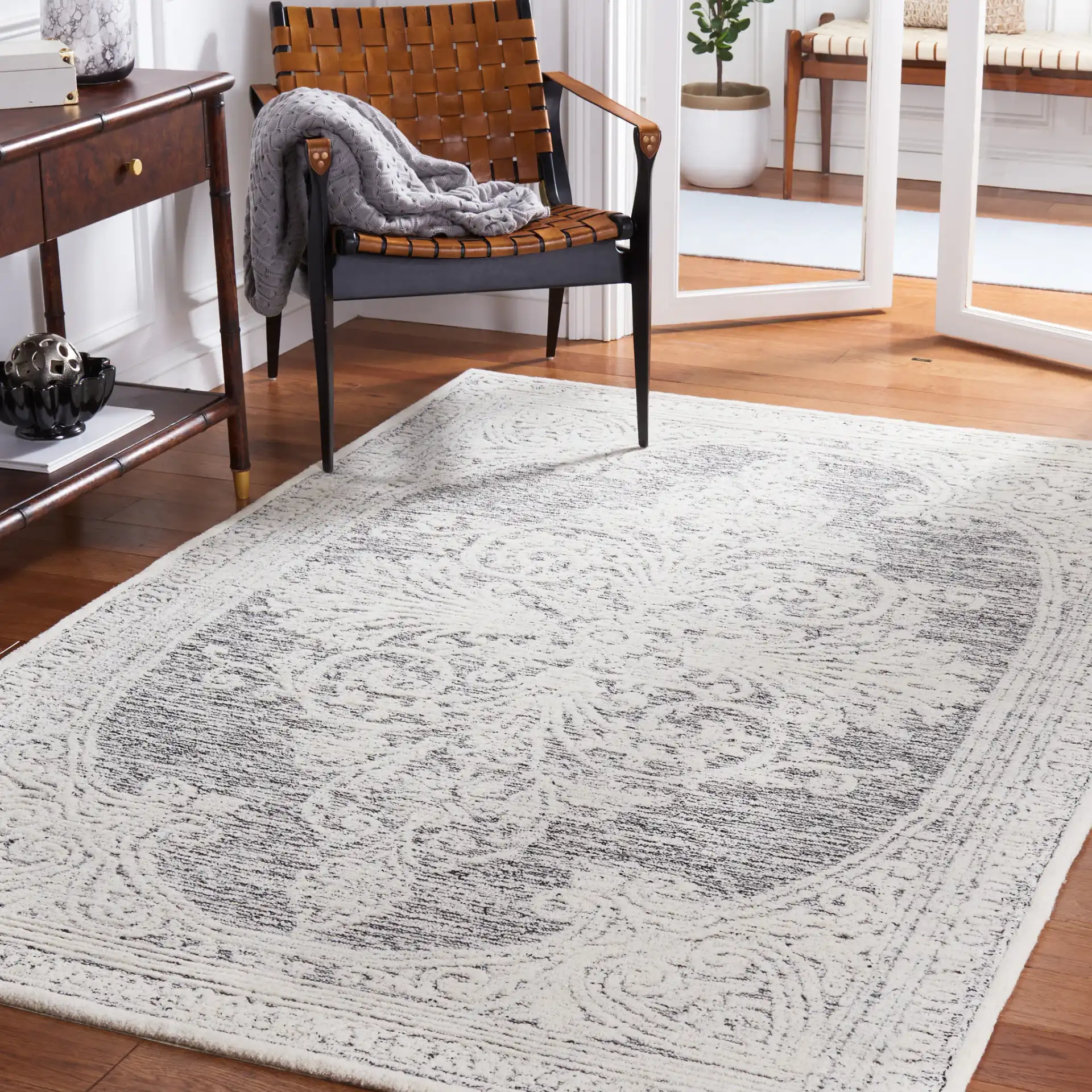 Metro Scroll Medallion Hand-Tufted Wool Rug in Ivory / Black in a styled room