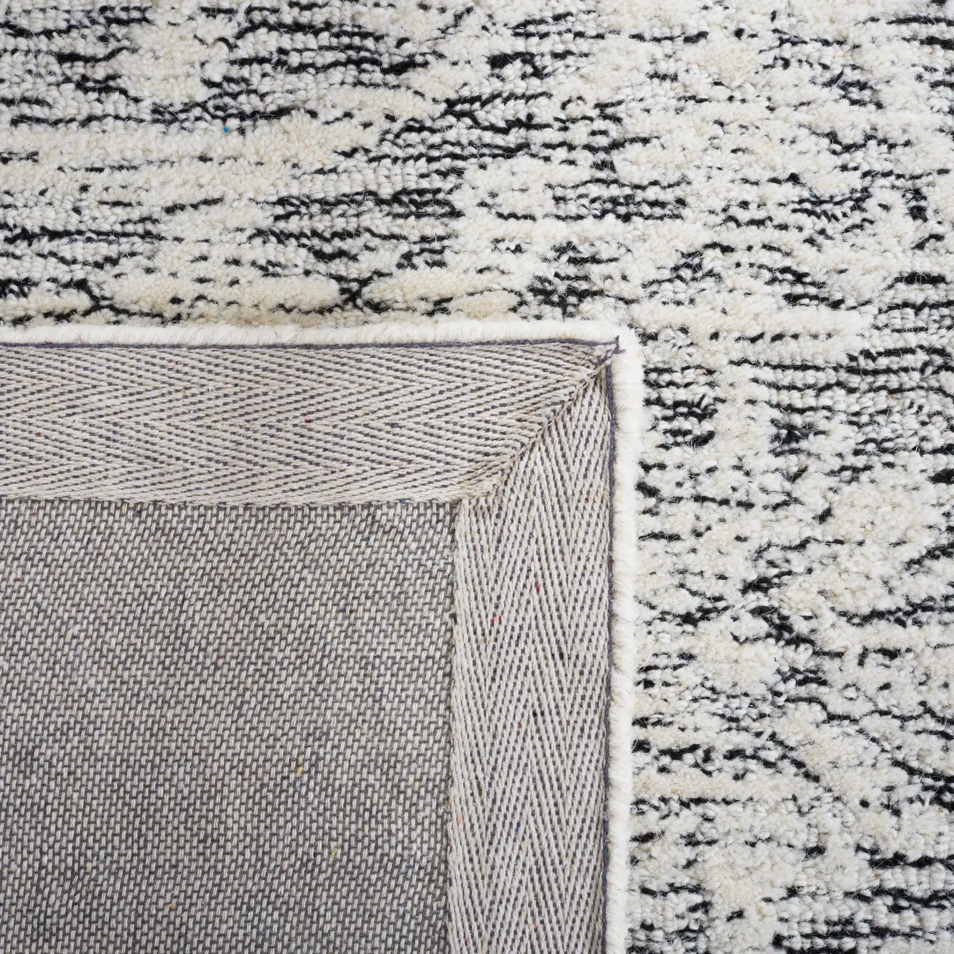 Metro Scroll Medallion Hand-Tufted Wool Rug in Ivory / Black in a styled room