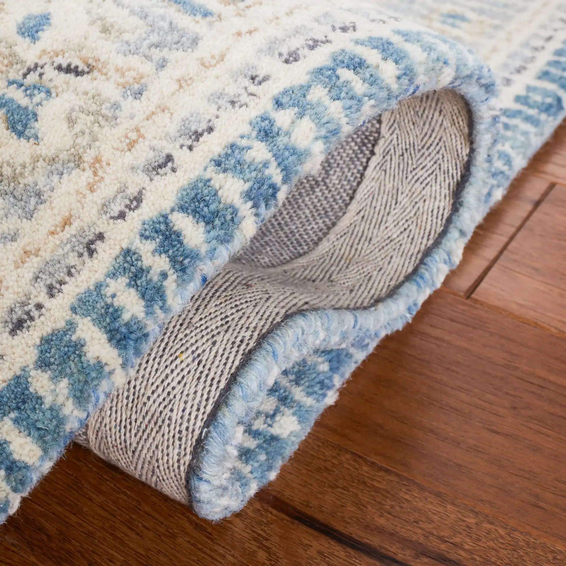 Metro Framed Medallion Hand-Tufted Wool Rug in Blue / Ivory in a styled room