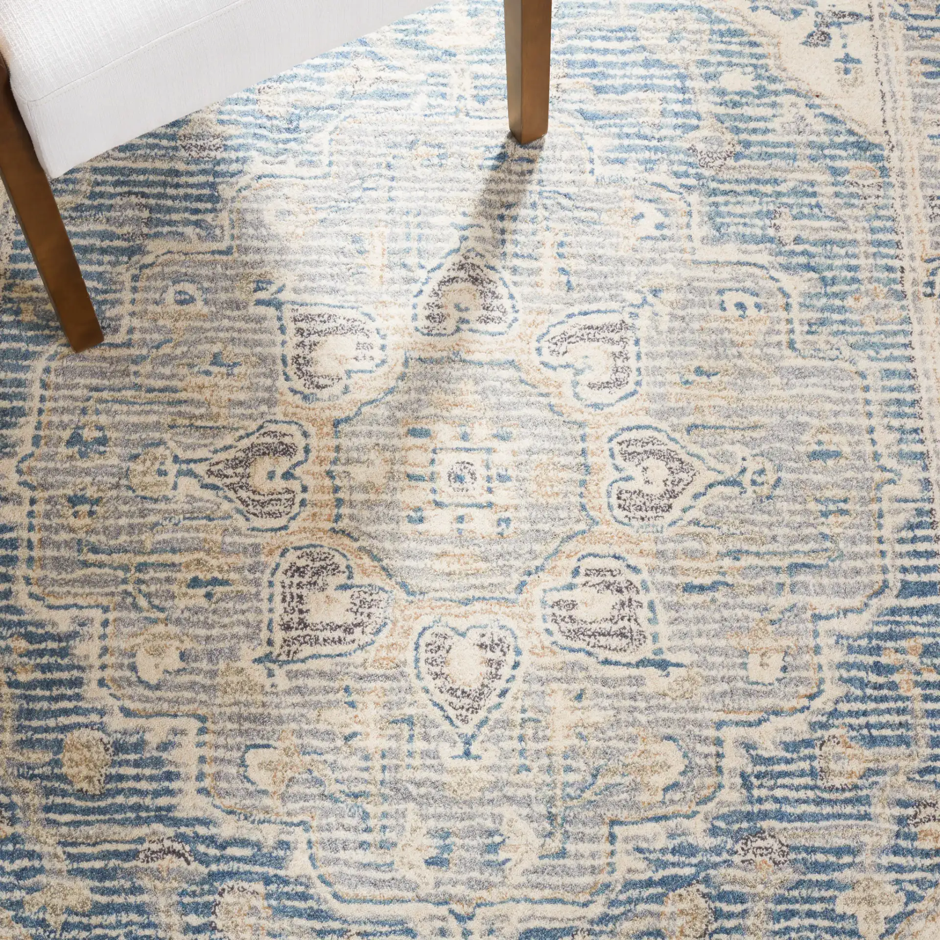 Metro Framed Medallion Hand-Tufted Wool Rug in Blue / Ivory in a styled room