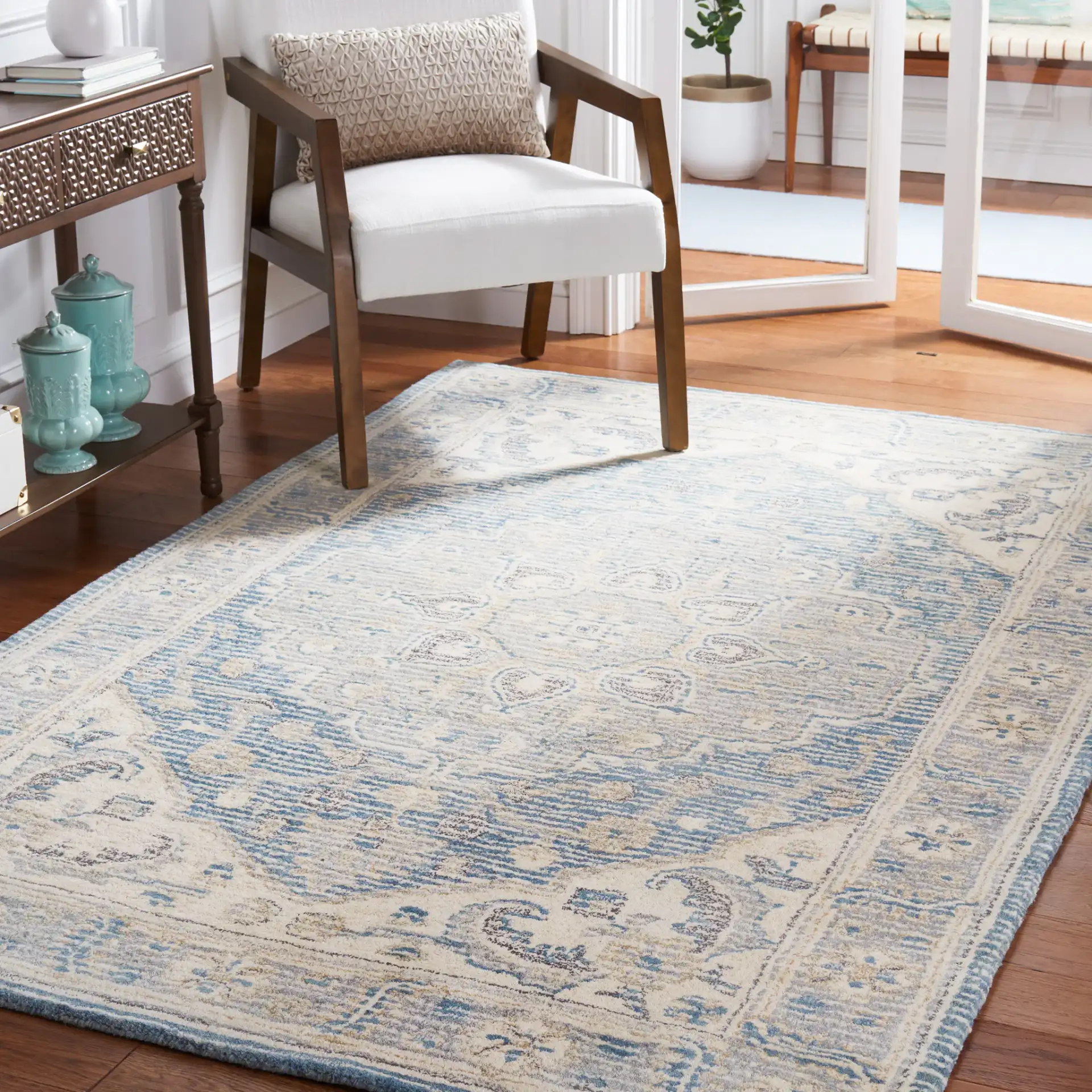 Metro Framed Medallion Hand-Tufted Wool Rug in Blue / Ivory in a styled room