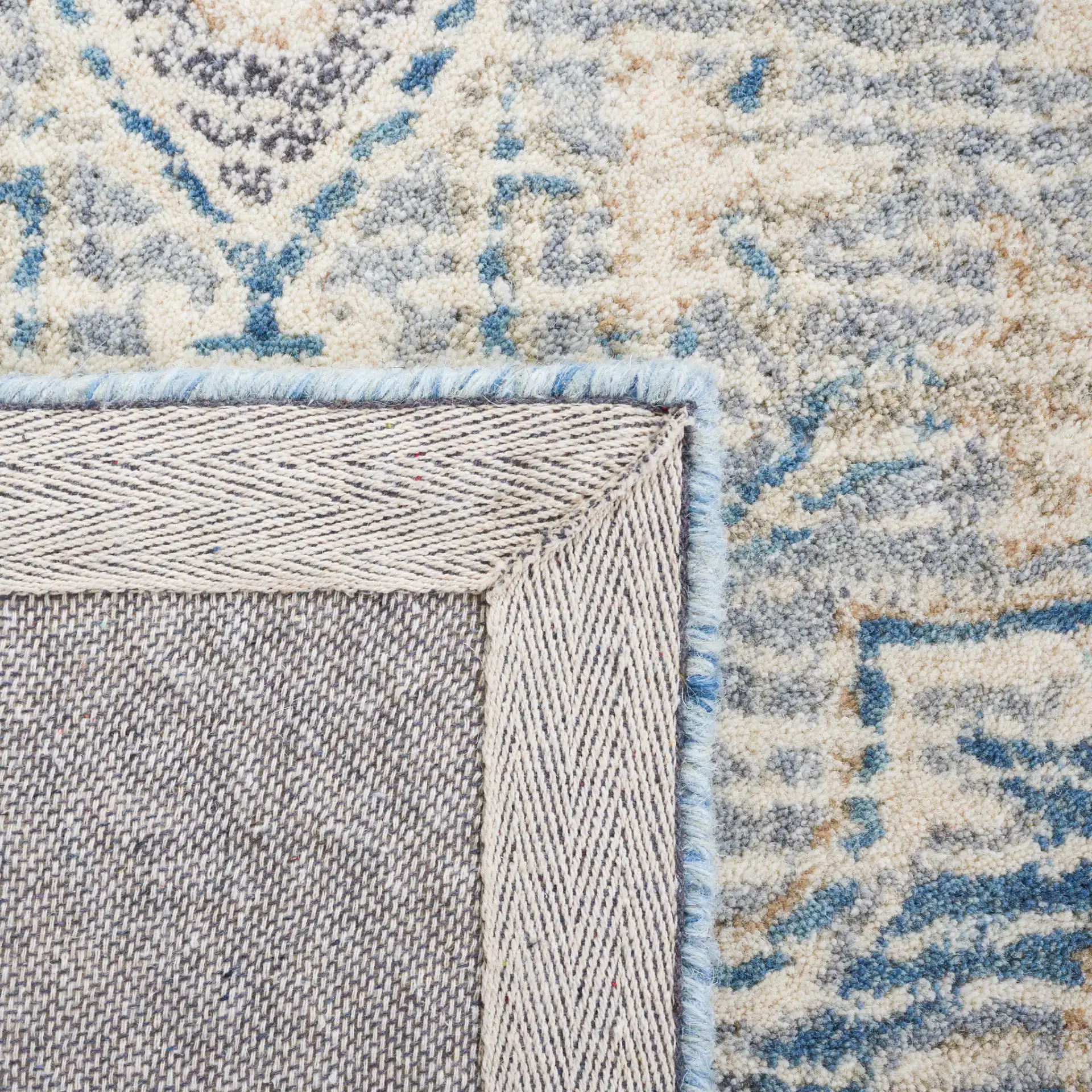 Metro Framed Medallion Hand-Tufted Wool Rug in Blue / Ivory in a styled room