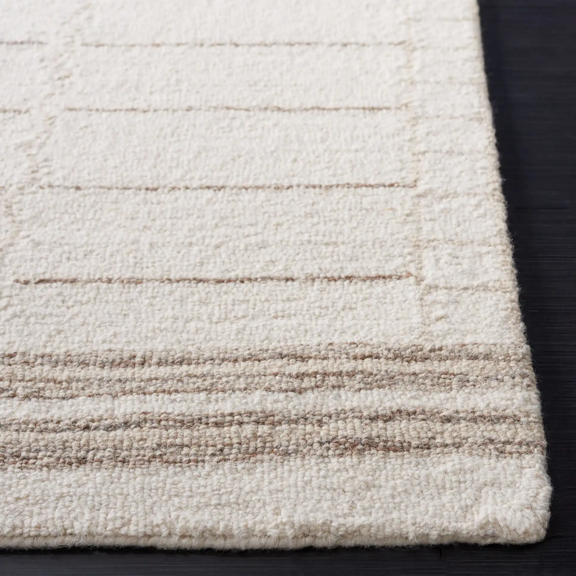 Metro Bordered Grid Hand-Tufted Wool Rug in Ivory / Brown in a styled room