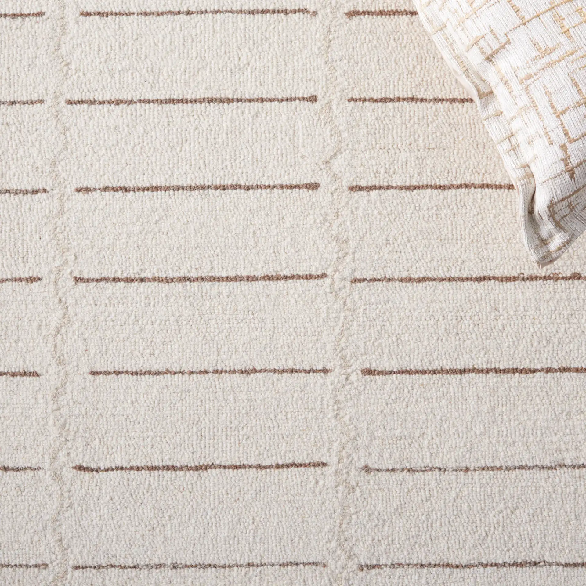 Metro Bordered Grid Hand-Tufted Wool Rug in Ivory / Brown in a styled room