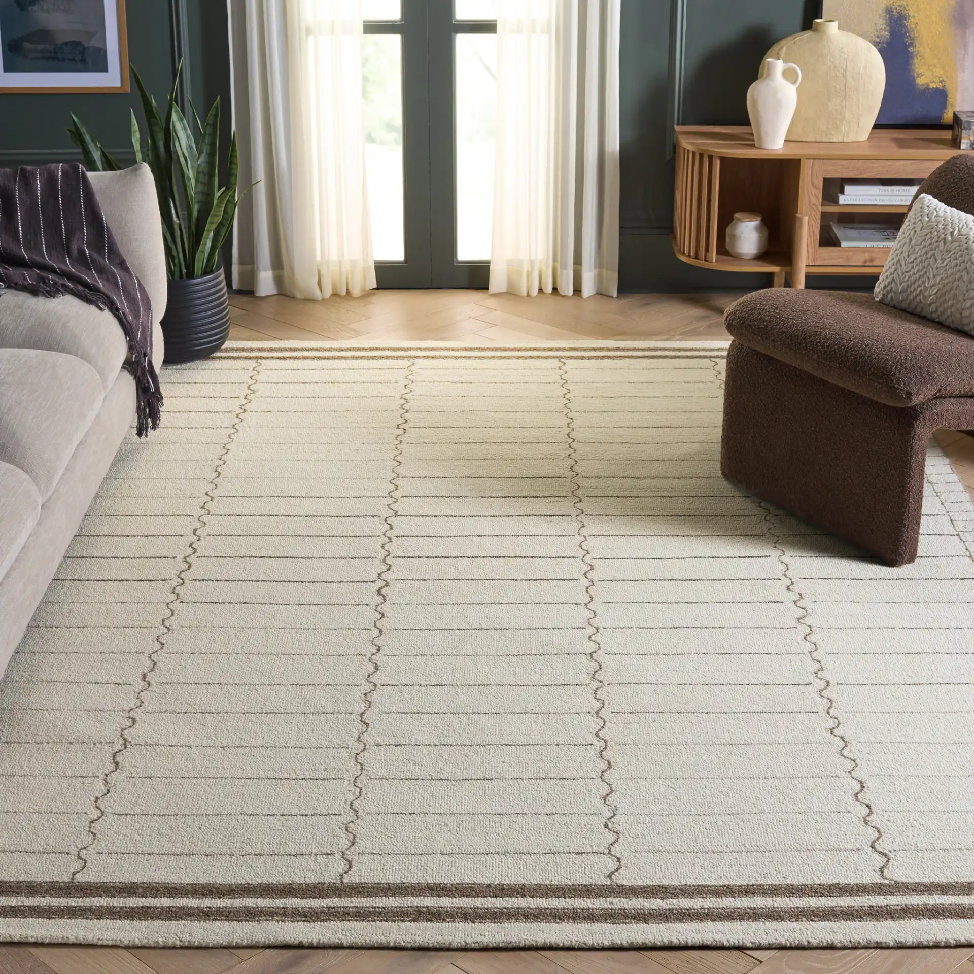 Metro Bordered Grid Hand-Tufted Wool Rug in Ivory / Brown in a styled room