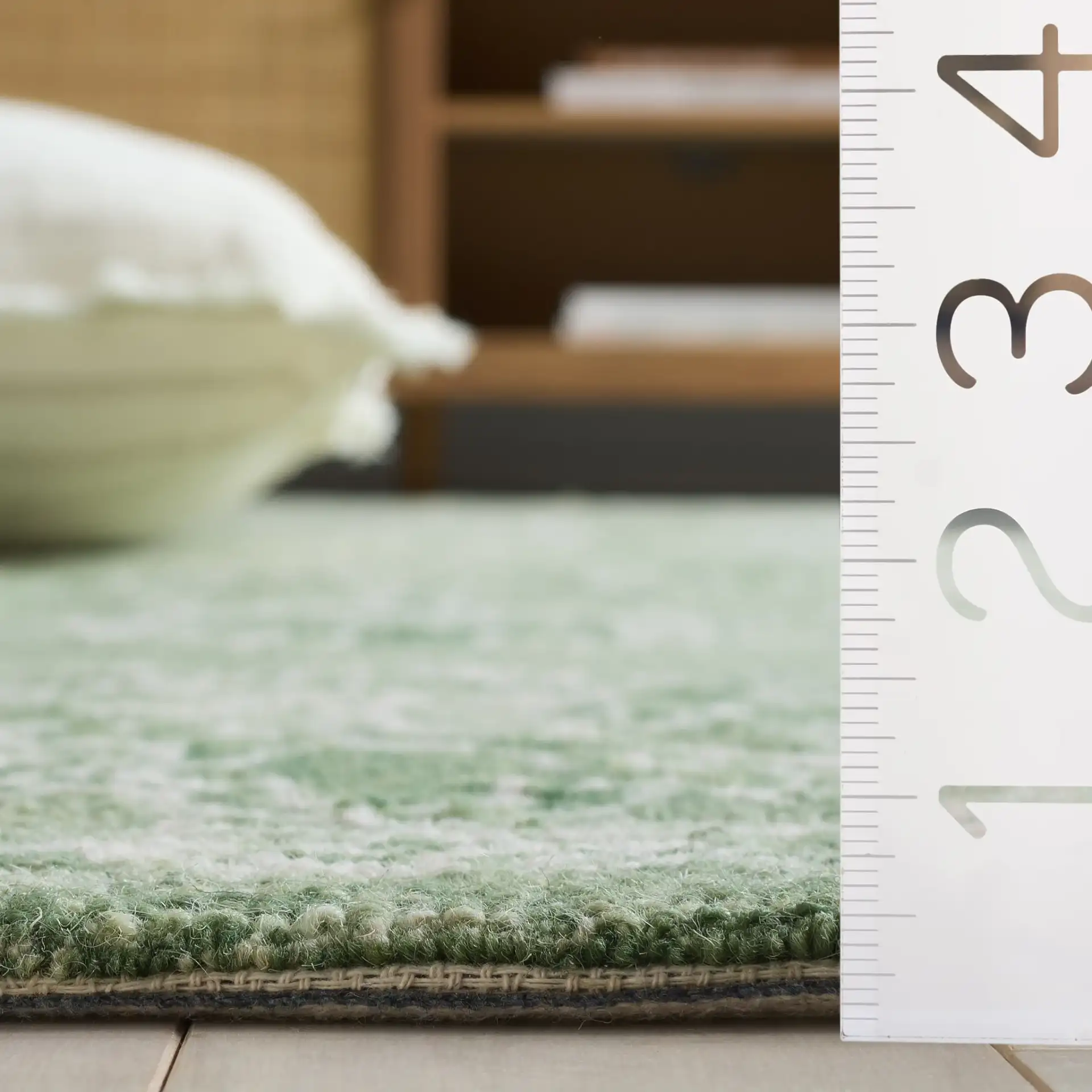 Metro Acanthus Scroll Hand-Tufted Wool Rug in Sage / Green in a styled room