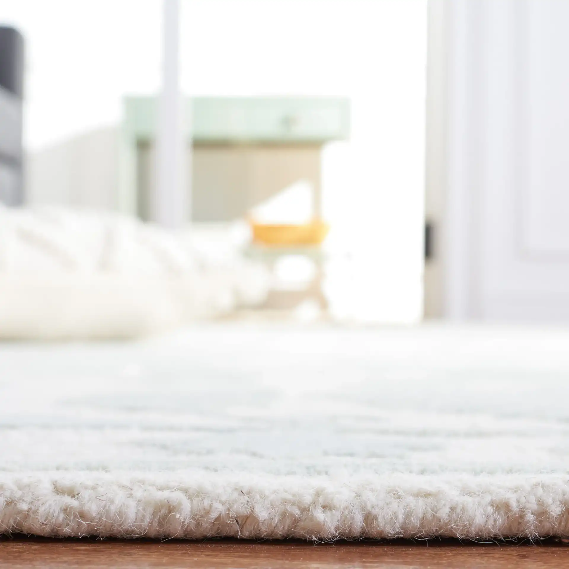 Metro Floral Vine Arabesque Hand-Tufted Wool Rug in Ivory / Light Green in a styled room