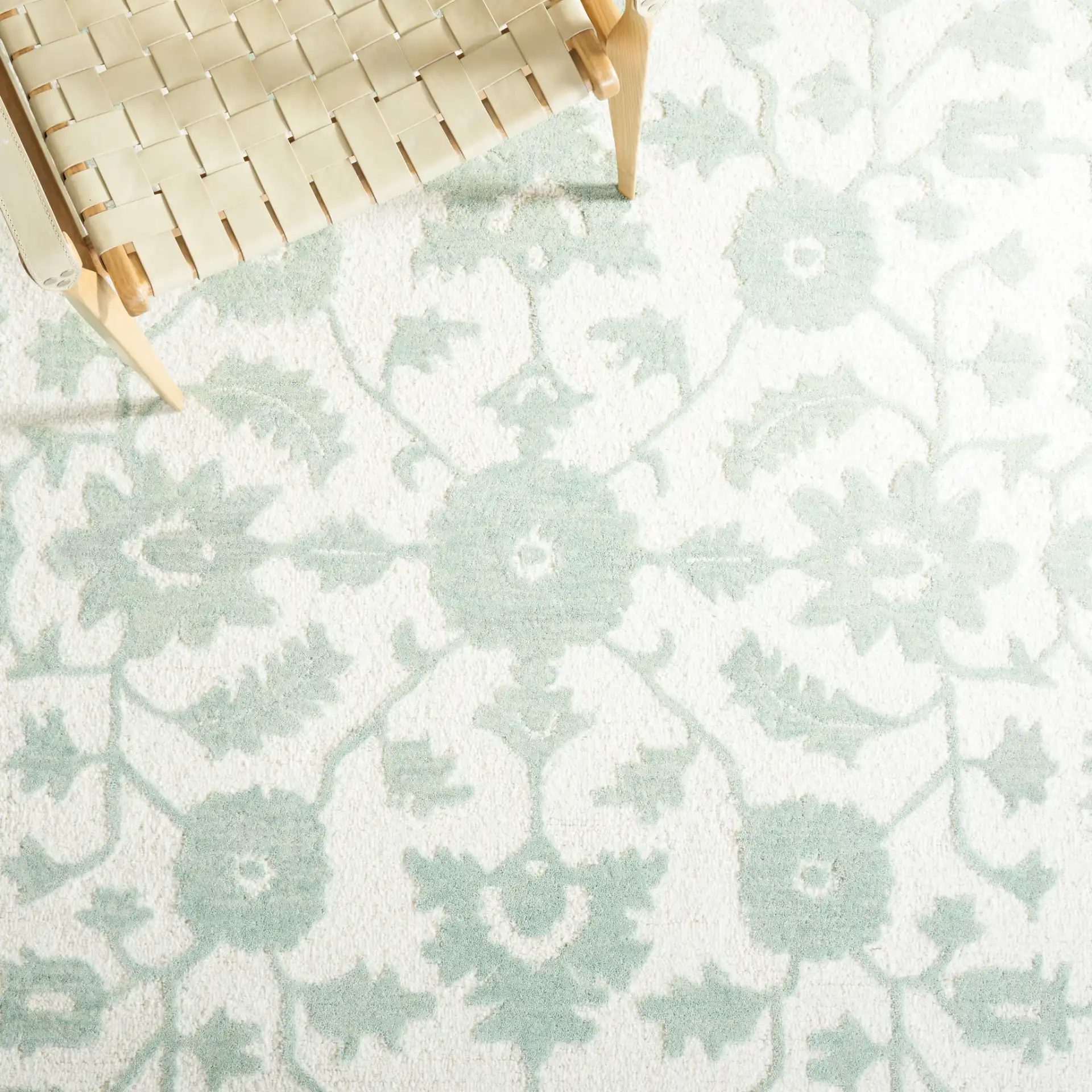 Metro Floral Vine Arabesque Hand-Tufted Wool Rug in Ivory / Light Green in a styled room