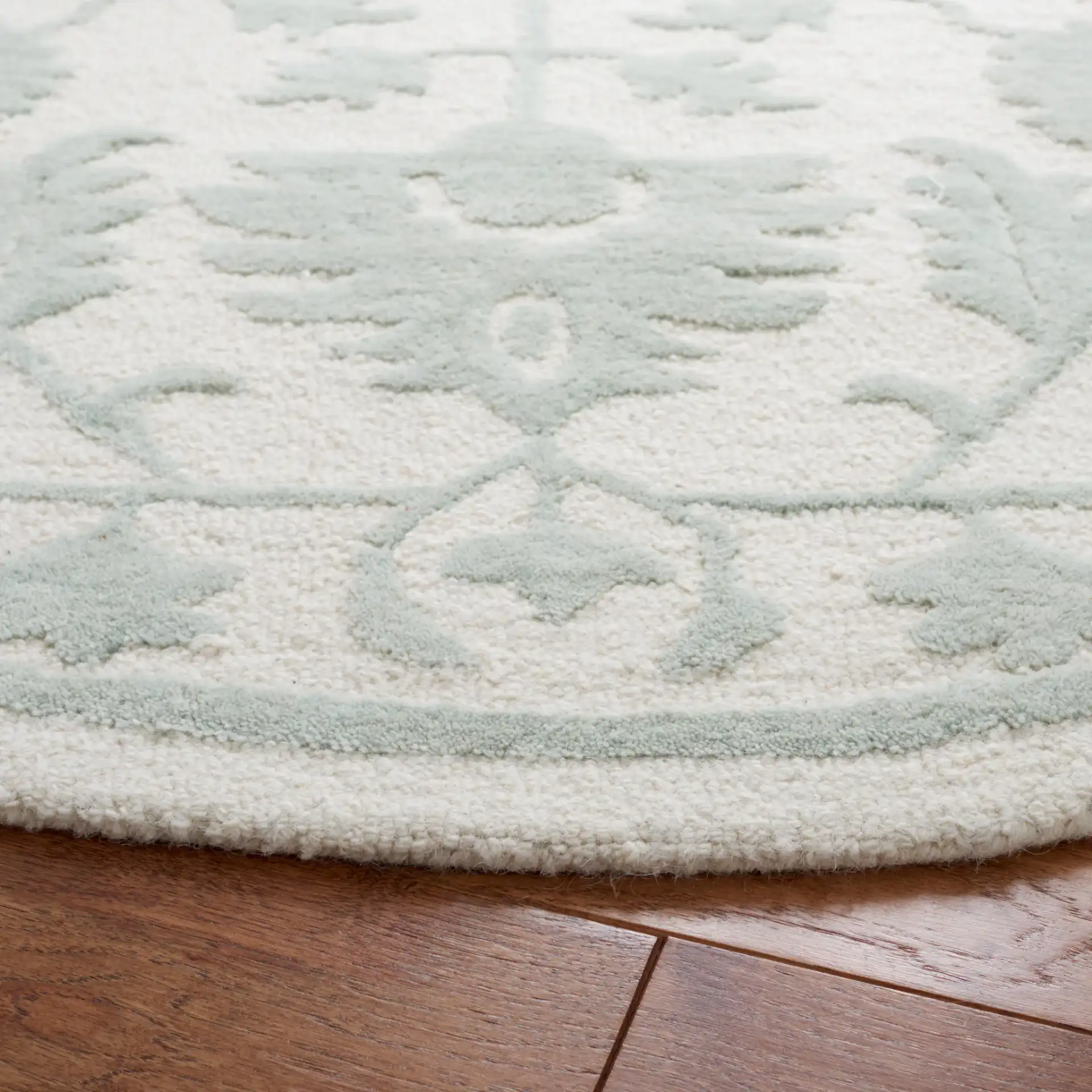 Metro Floral Vine Arabesque Hand-Tufted Wool Rug in Ivory / Light Green in a styled room