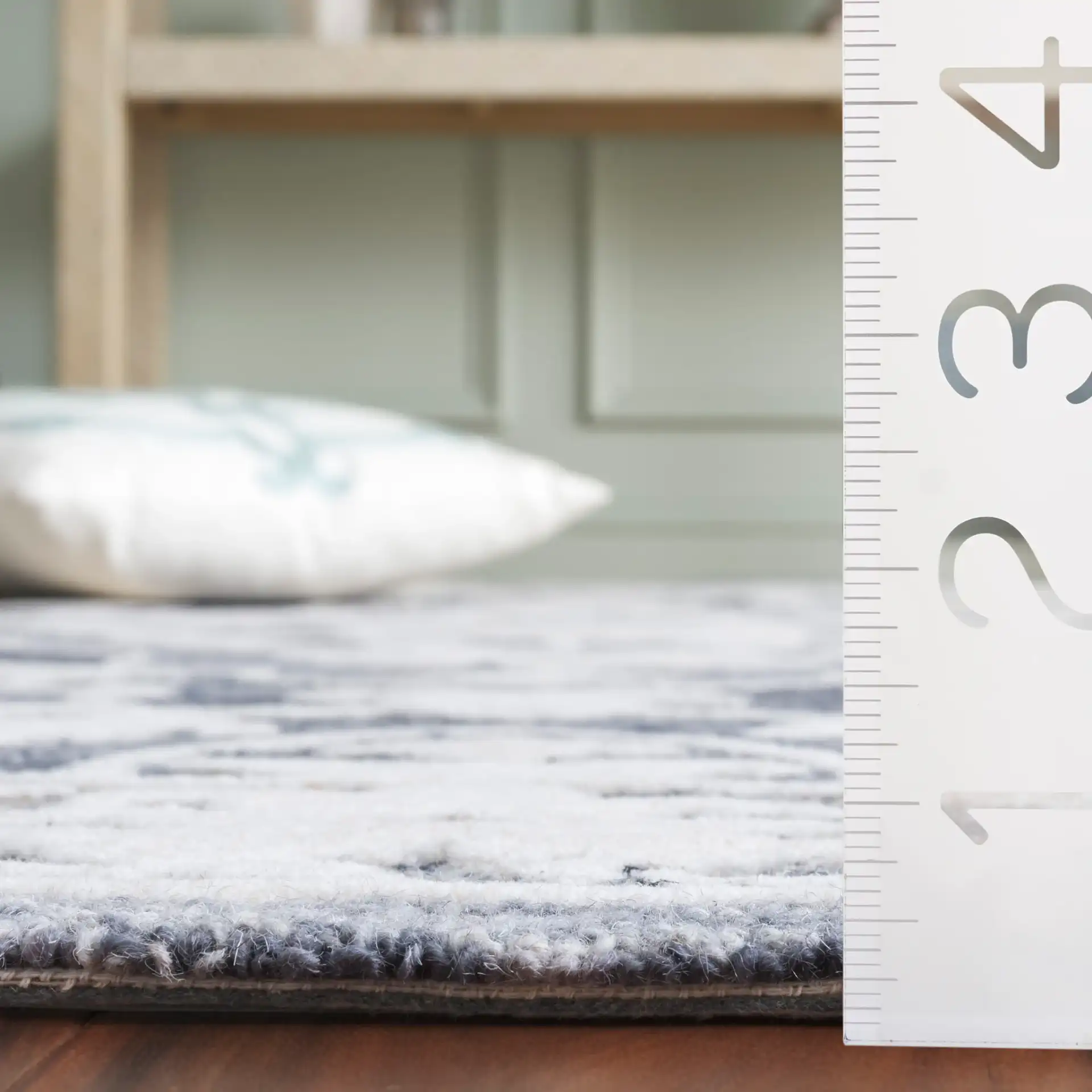 Metro Medallion Border Hand-Tufted Wool Rug in Light Blue / Gray in a styled room