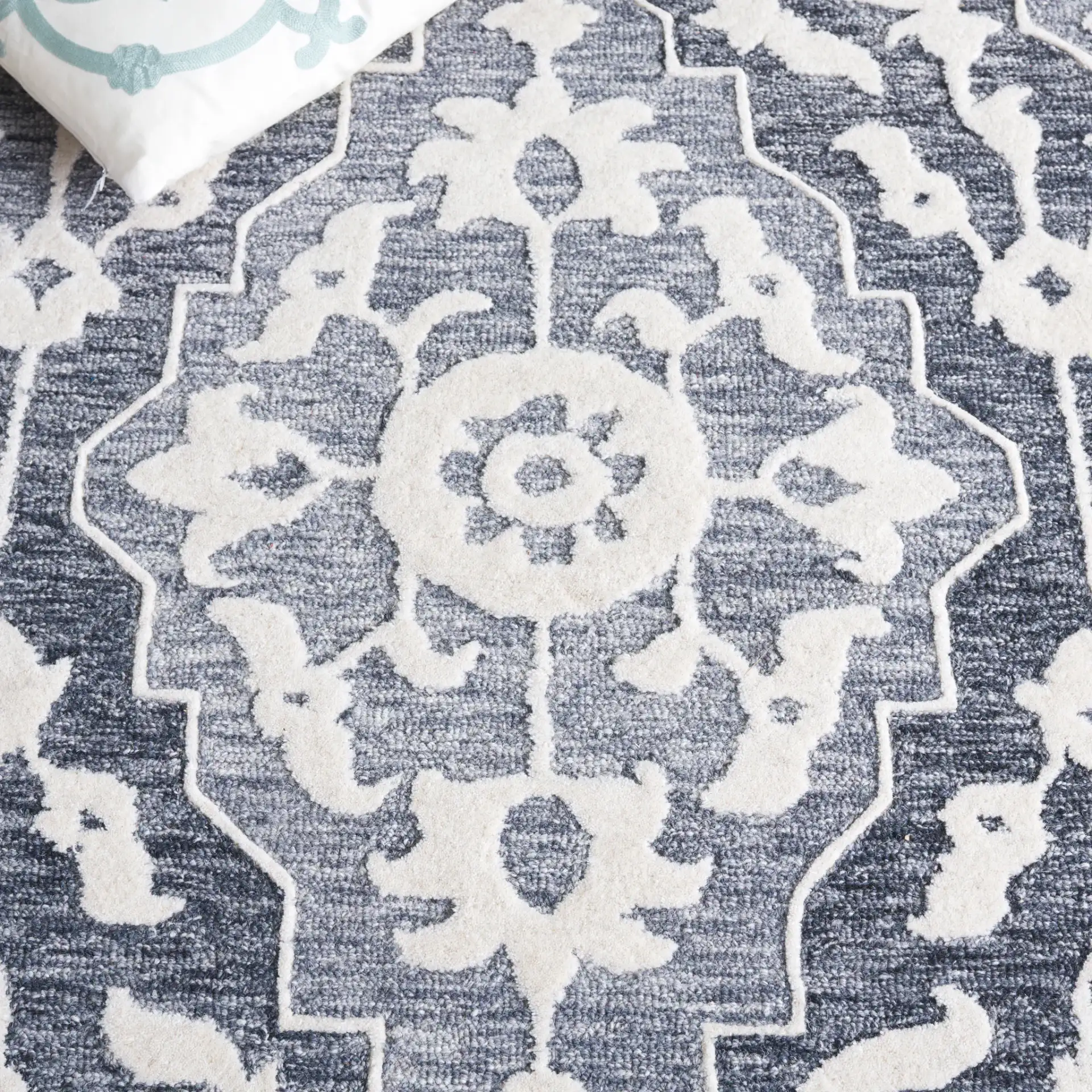 Metro Medallion Border Hand-Tufted Wool Rug in Light Blue / Gray in a styled room