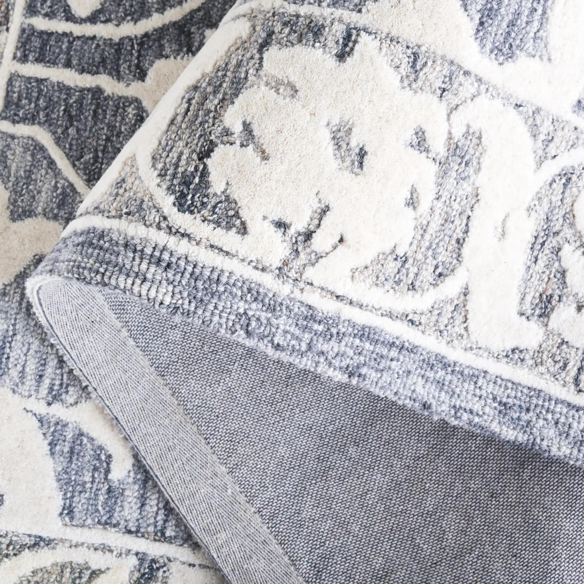 Metro Medallion Border Hand-Tufted Wool Rug in Light Blue / Gray in a styled room