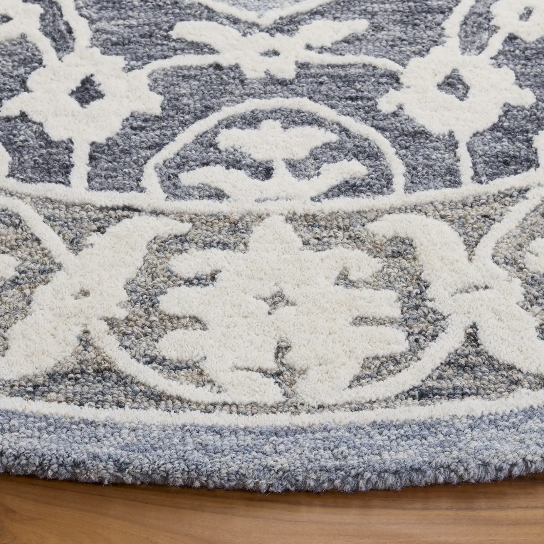 Metro Medallion Border Hand-Tufted Wool Rug in Light Blue / Gray in a styled room