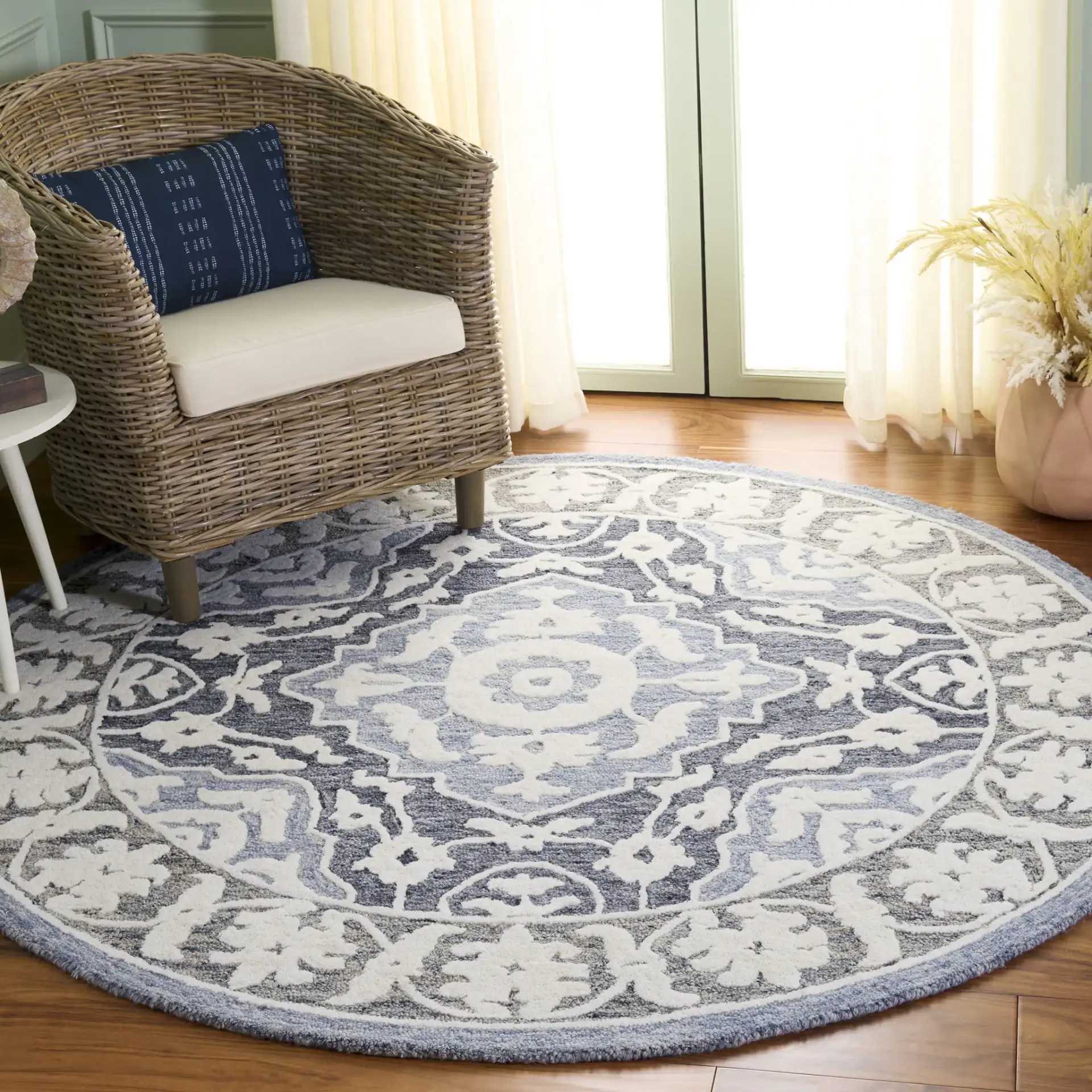 Metro Medallion Border Hand-Tufted Wool Rug in Light Blue / Gray in a styled room