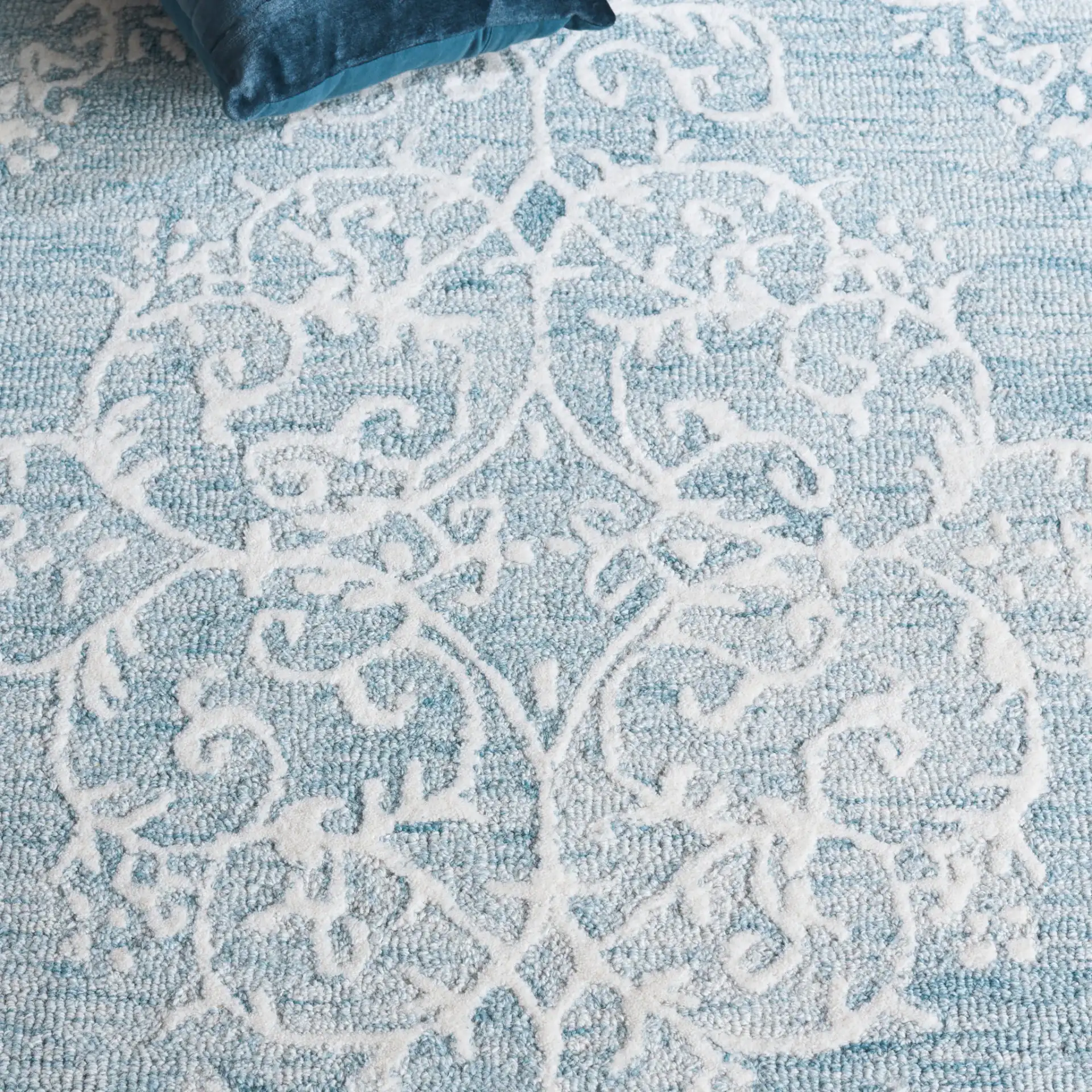 Metro Corner Medallion Hand-Tufted Wool Rug in Blue / Ivory in a styled room