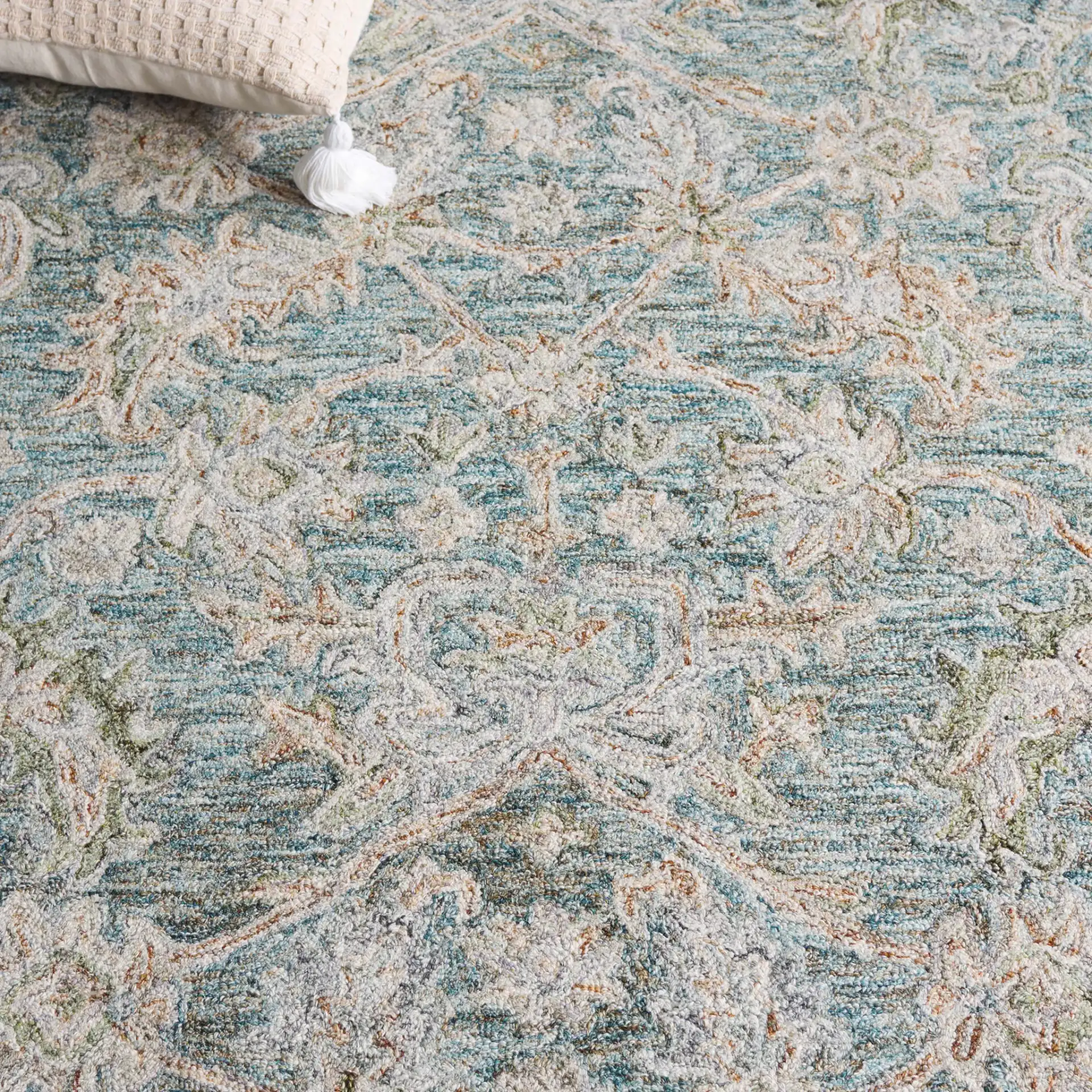 Metro Floral Trellis Hand-Tufted Wool Rug in Teal / Green in a styled room