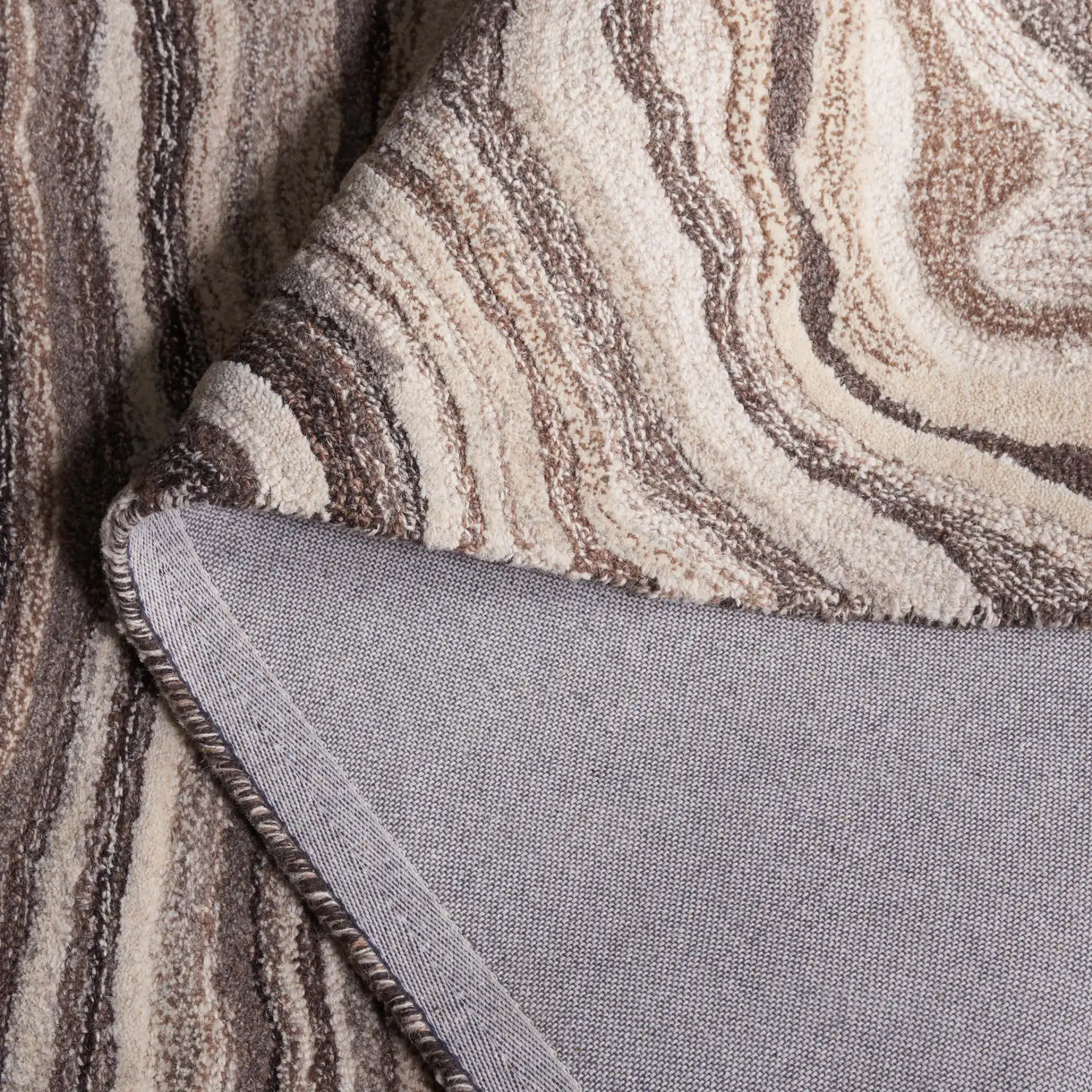 Metro Swirl Marble Hand-Tufted Wool Rug in Brown / Ivory in a styled room