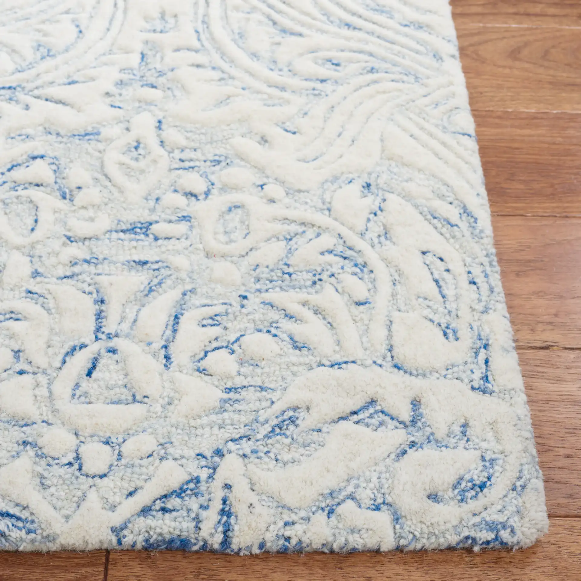 Metro Ornamental Damask Hand-Tufted Wool Rug in Blue / Ivory in a styled room