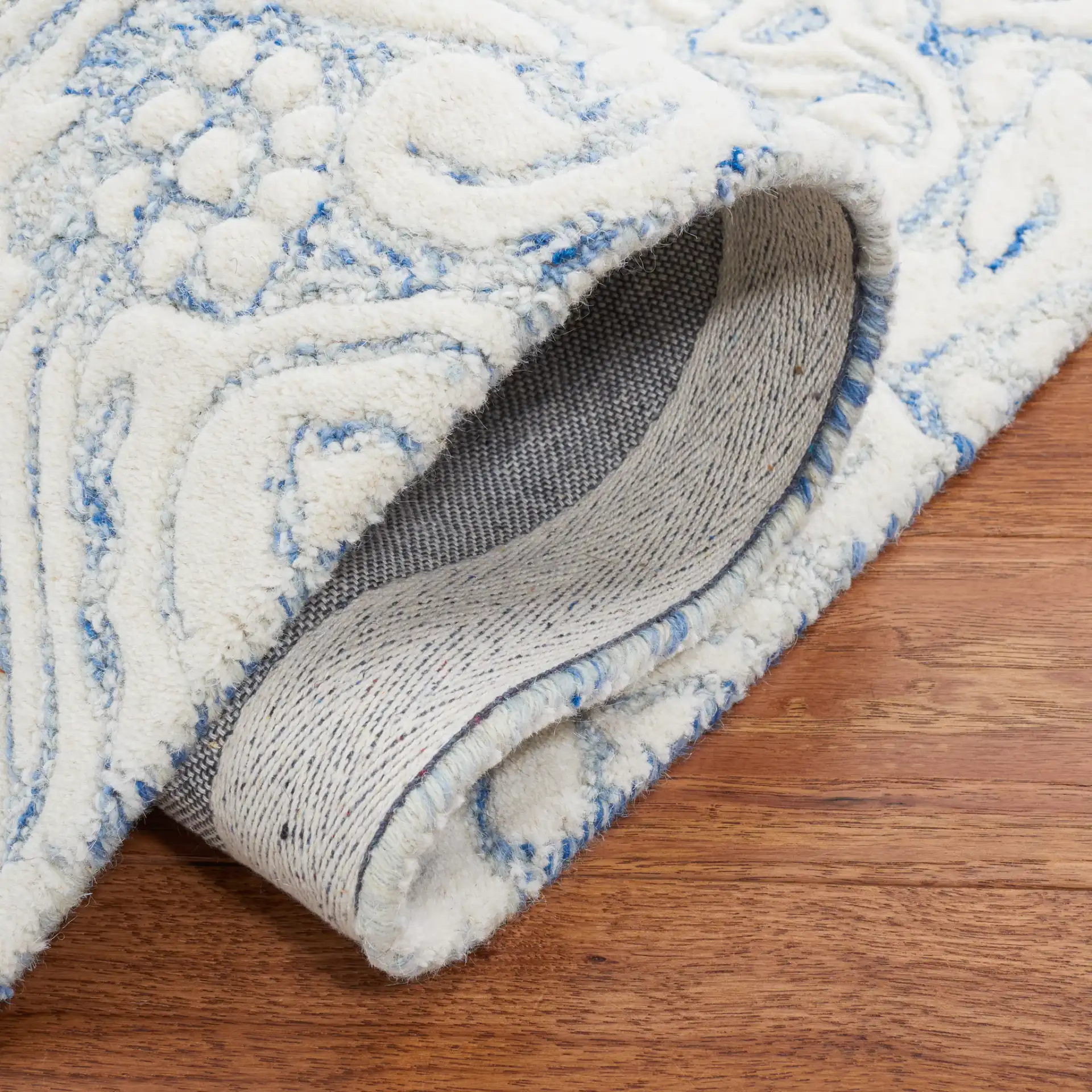 Metro Ornamental Damask Hand-Tufted Wool Rug in Blue / Ivory in a styled room
