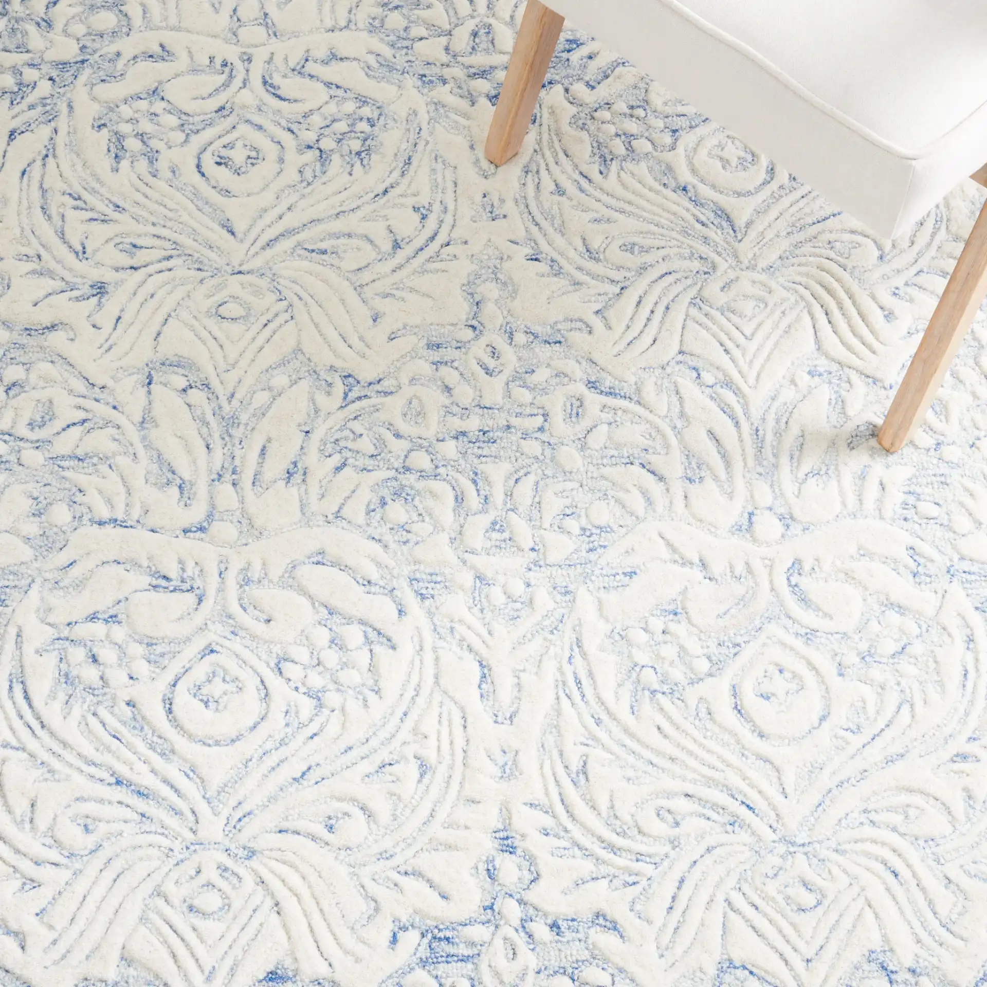 Metro Ornamental Damask Hand-Tufted Wool Rug in Blue / Ivory in a styled room