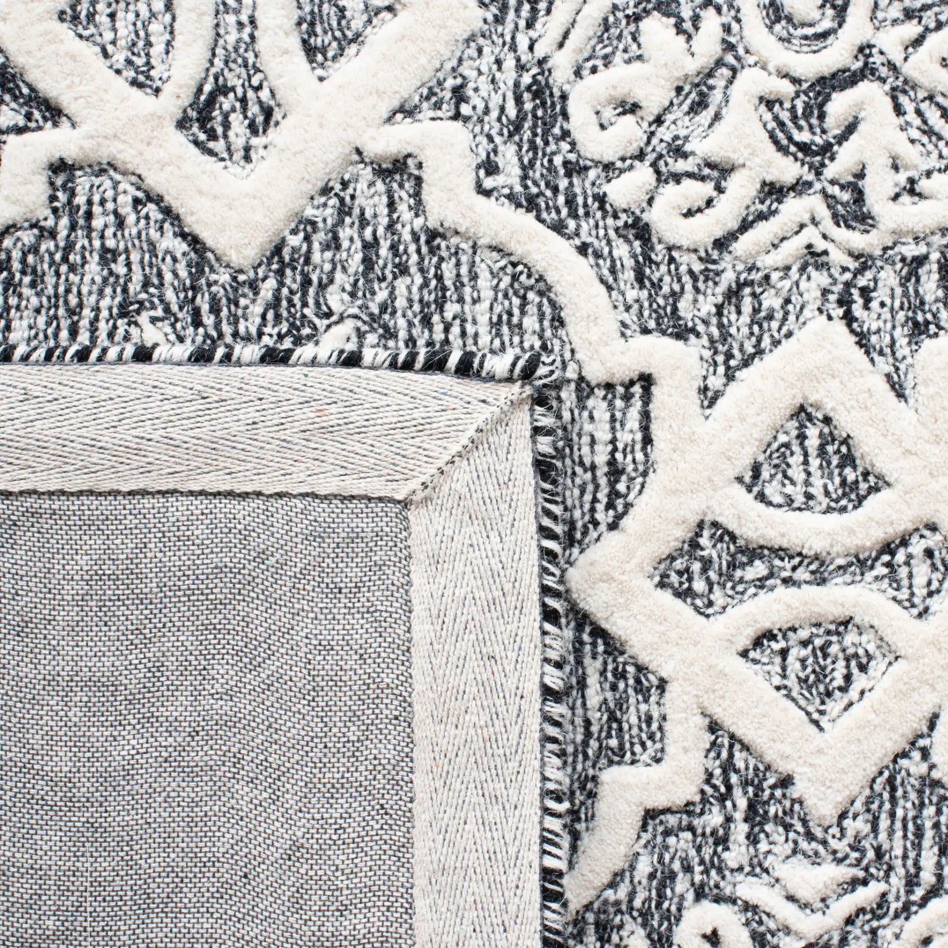 Metro Tile Bordered Hand-Tufted Wool Rug in Black / Ivory in a styled room
