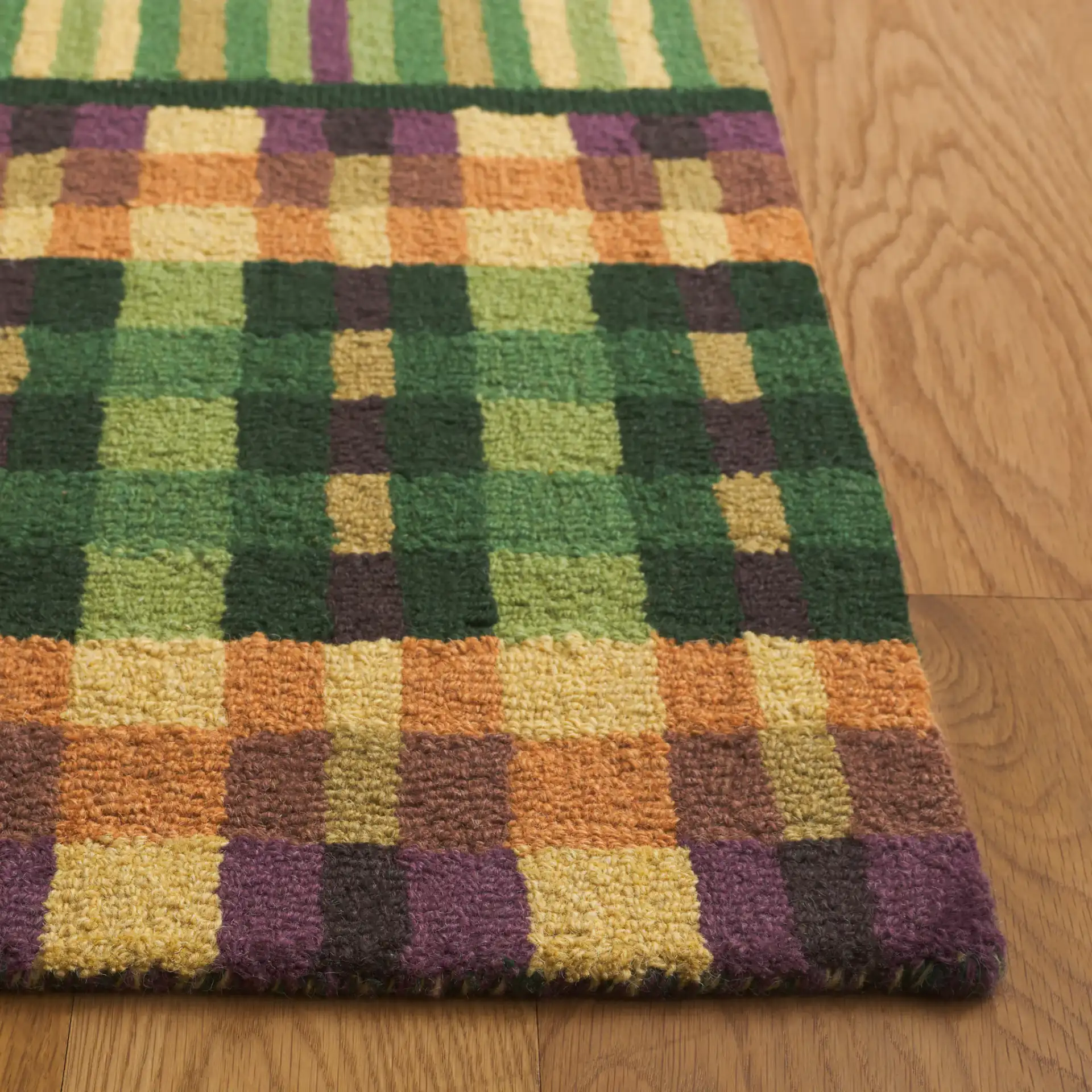 Metro Checkered And Striped Hand-Tufted Wool Rug in Green / Gold in a styled room