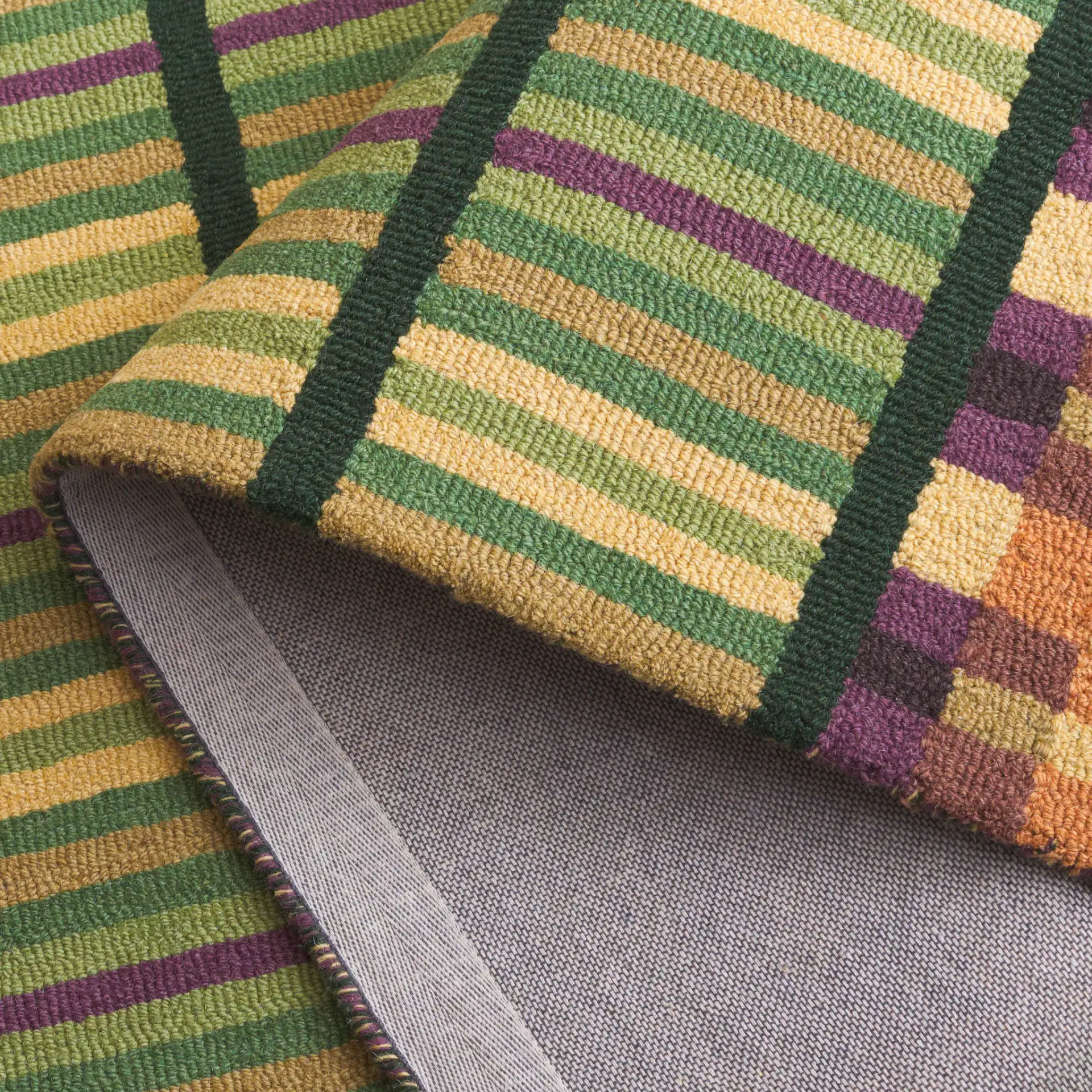 Metro Checkered And Striped Hand-Tufted Wool Rug in Green / Gold in a styled room