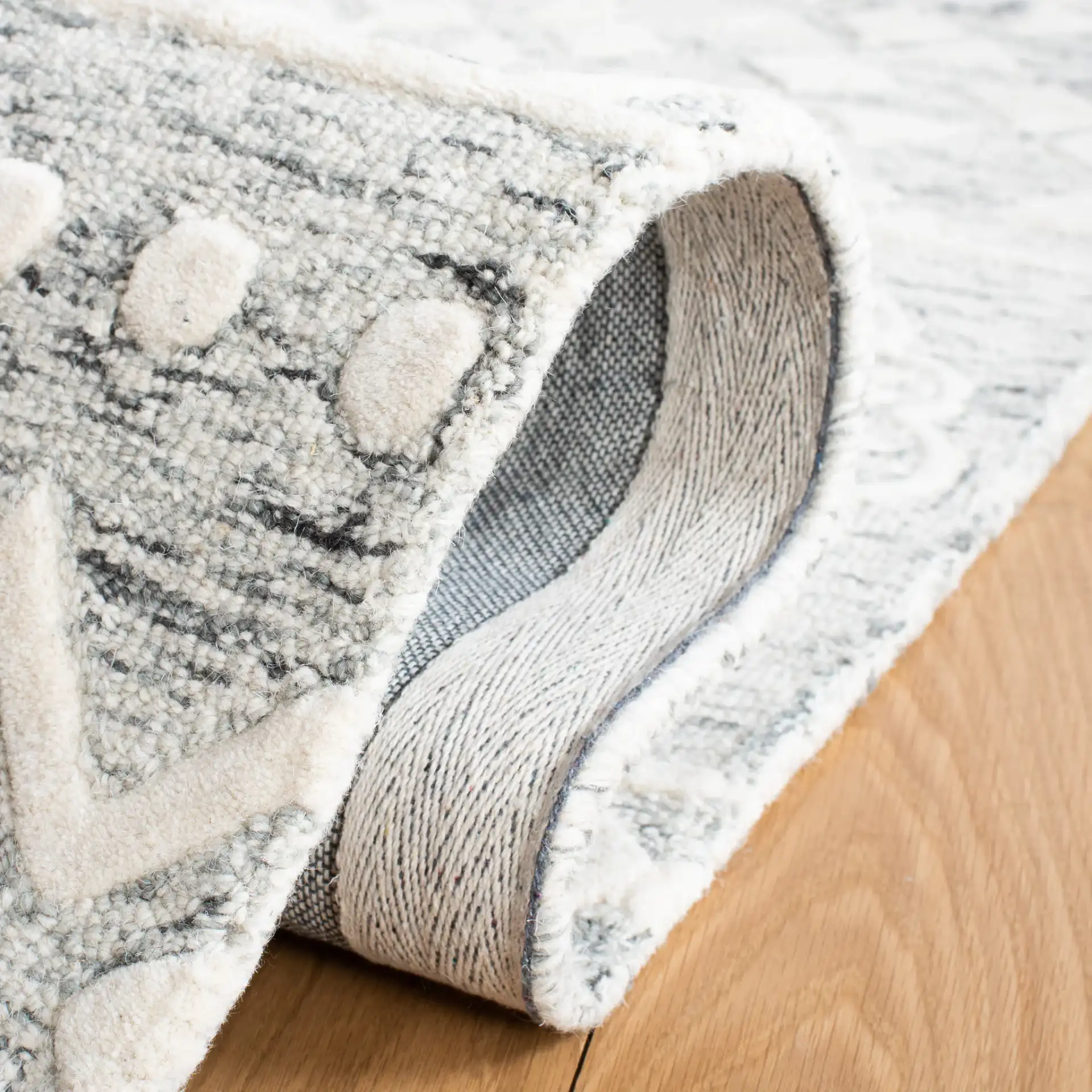 Metro Patchwork Tile Hand-Tufted Wool Rug in Silver / Ivory in a styled room