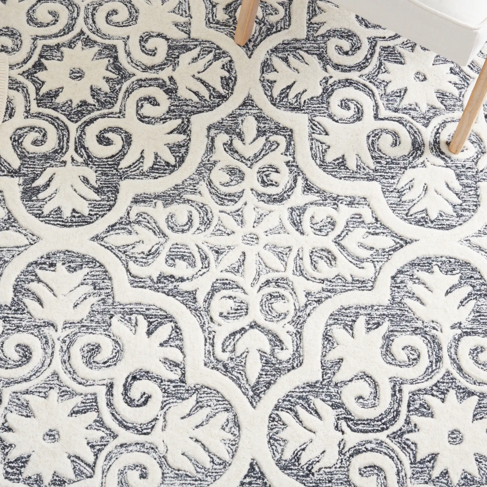 Metro Quatrefoil Tile Hand-Tufted Wool Rug in Black / Ivory in a styled room