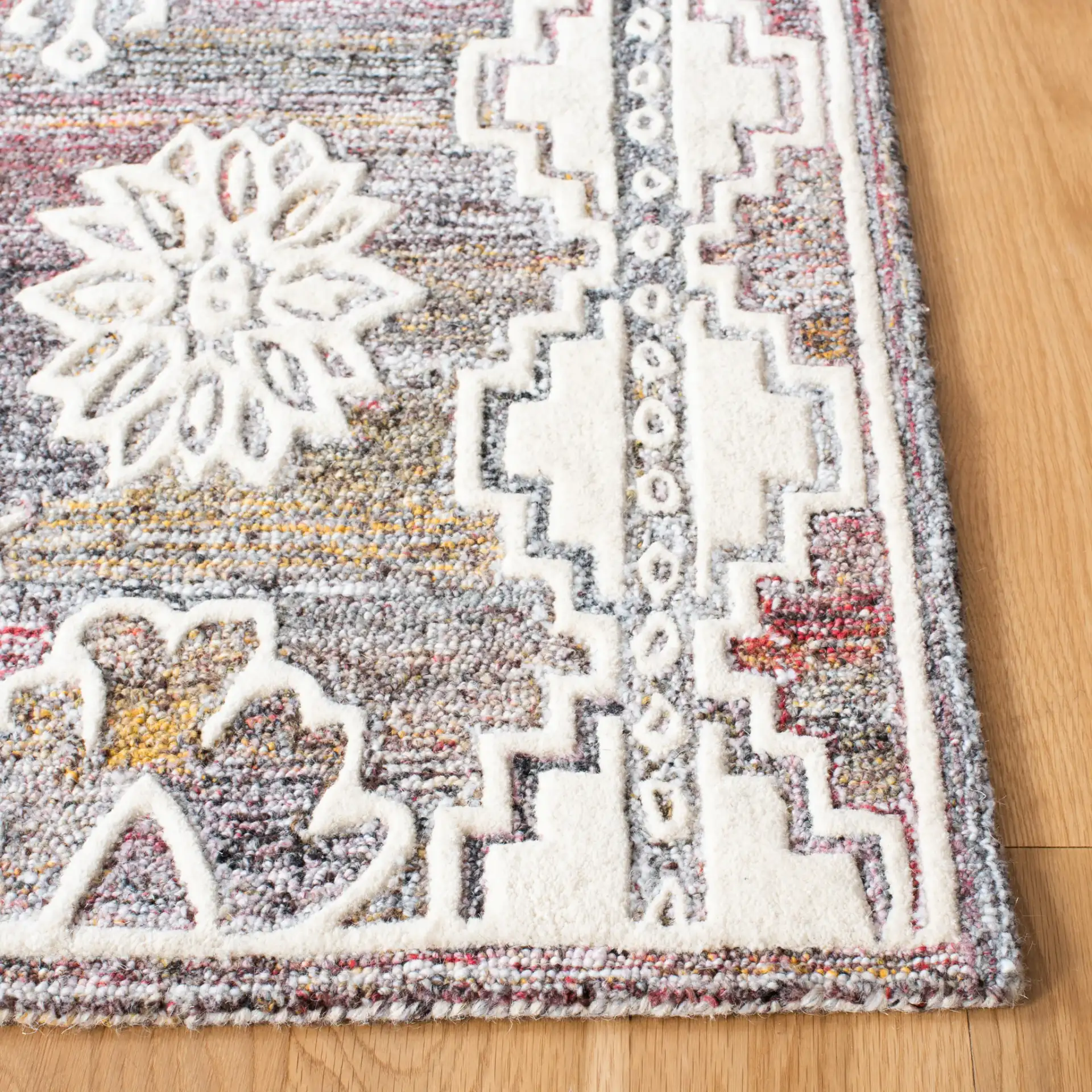 Metro Southwestern Medallion Hand-Tufted Wool Rug in Red / Ivory in a styled room