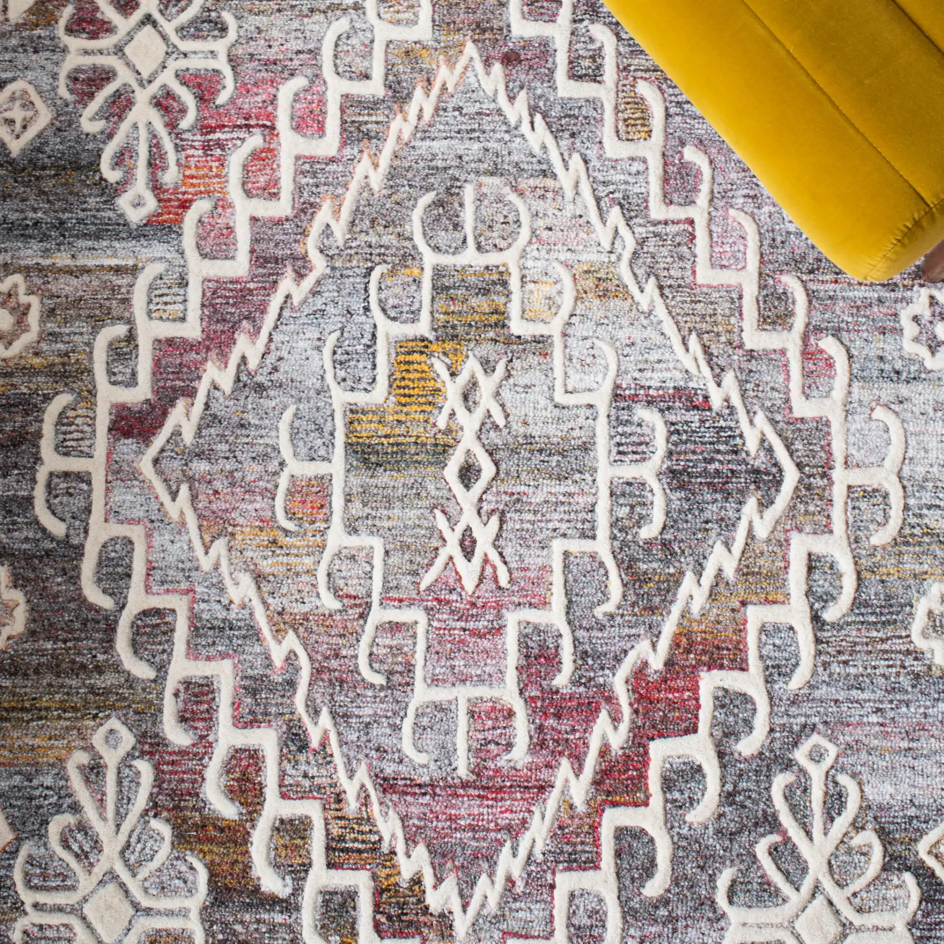 Metro Southwestern Medallion Hand-Tufted Wool Rug in Red / Ivory in a styled room