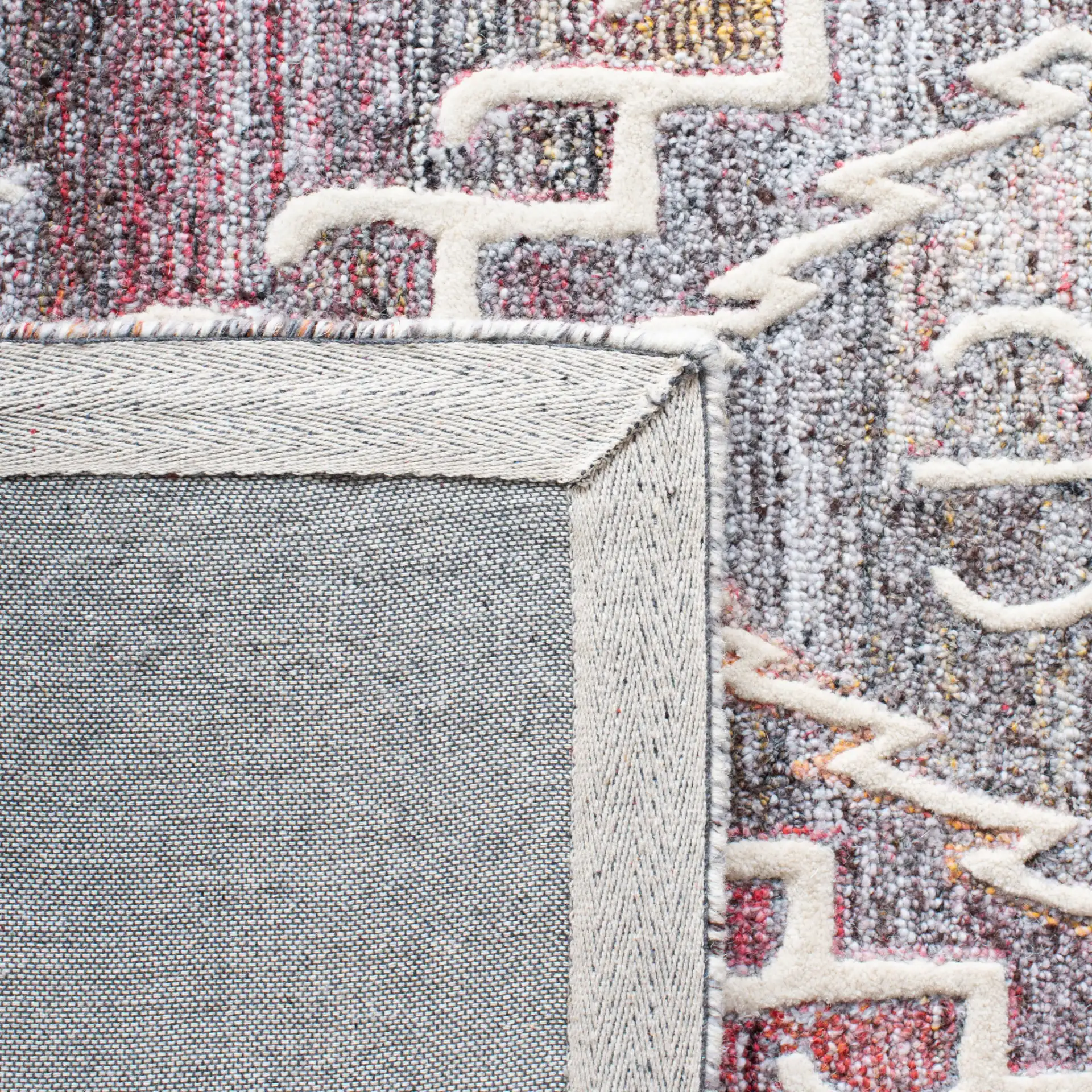 Metro Southwestern Medallion Hand-Tufted Wool Rug in Red / Ivory in a styled room