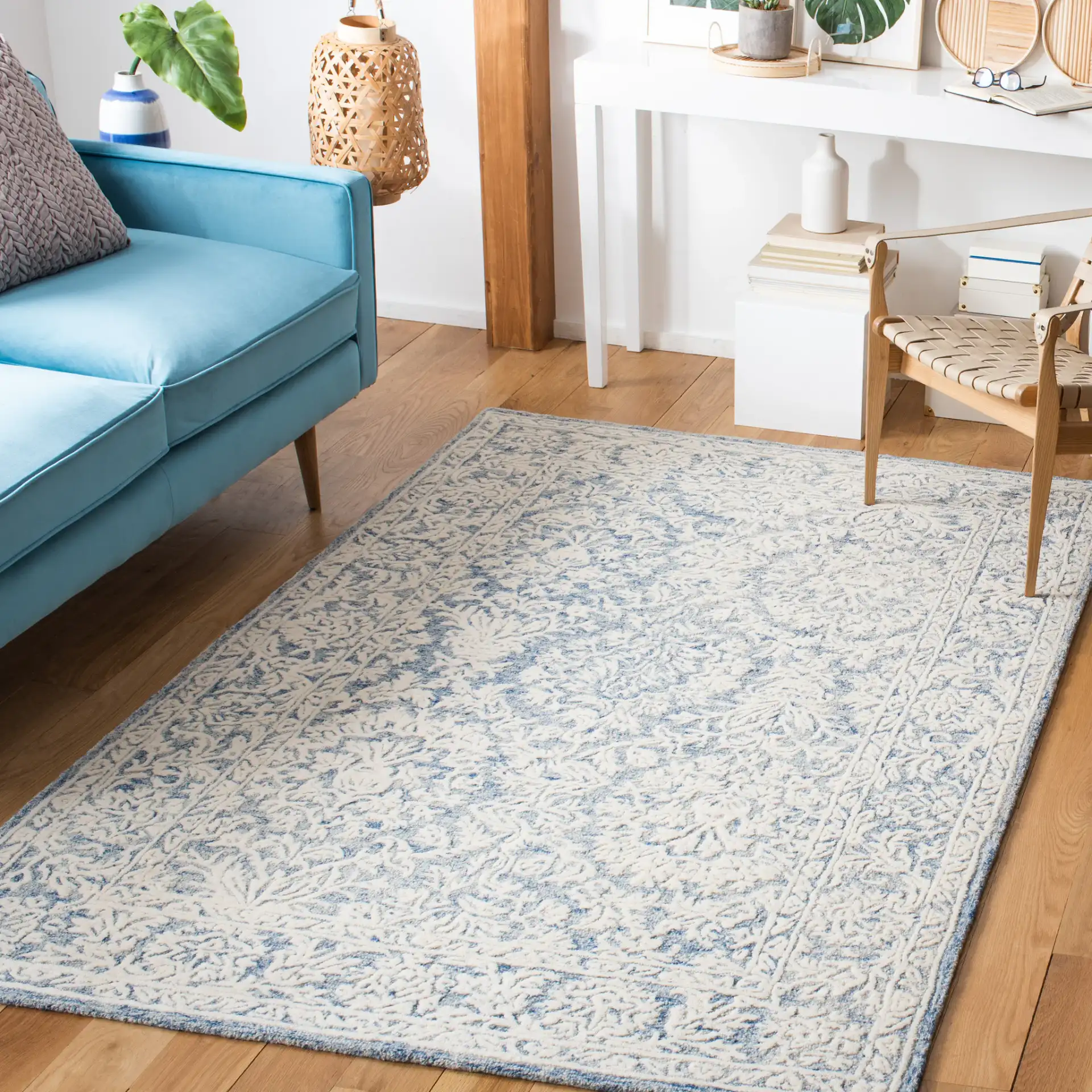 Metro Floral Border Hand-Tufted Wool Rug in Blue / Ivory in a styled room