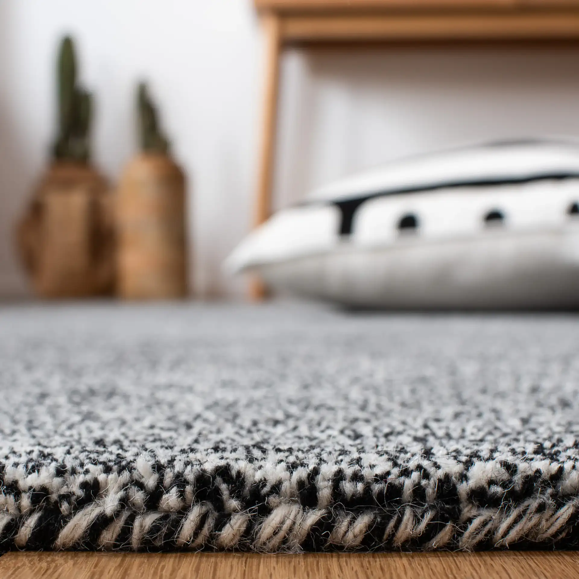 Metro Modern Heathered Solid Hand-Tufted Wool Rug in Black / Ivory in a styled room