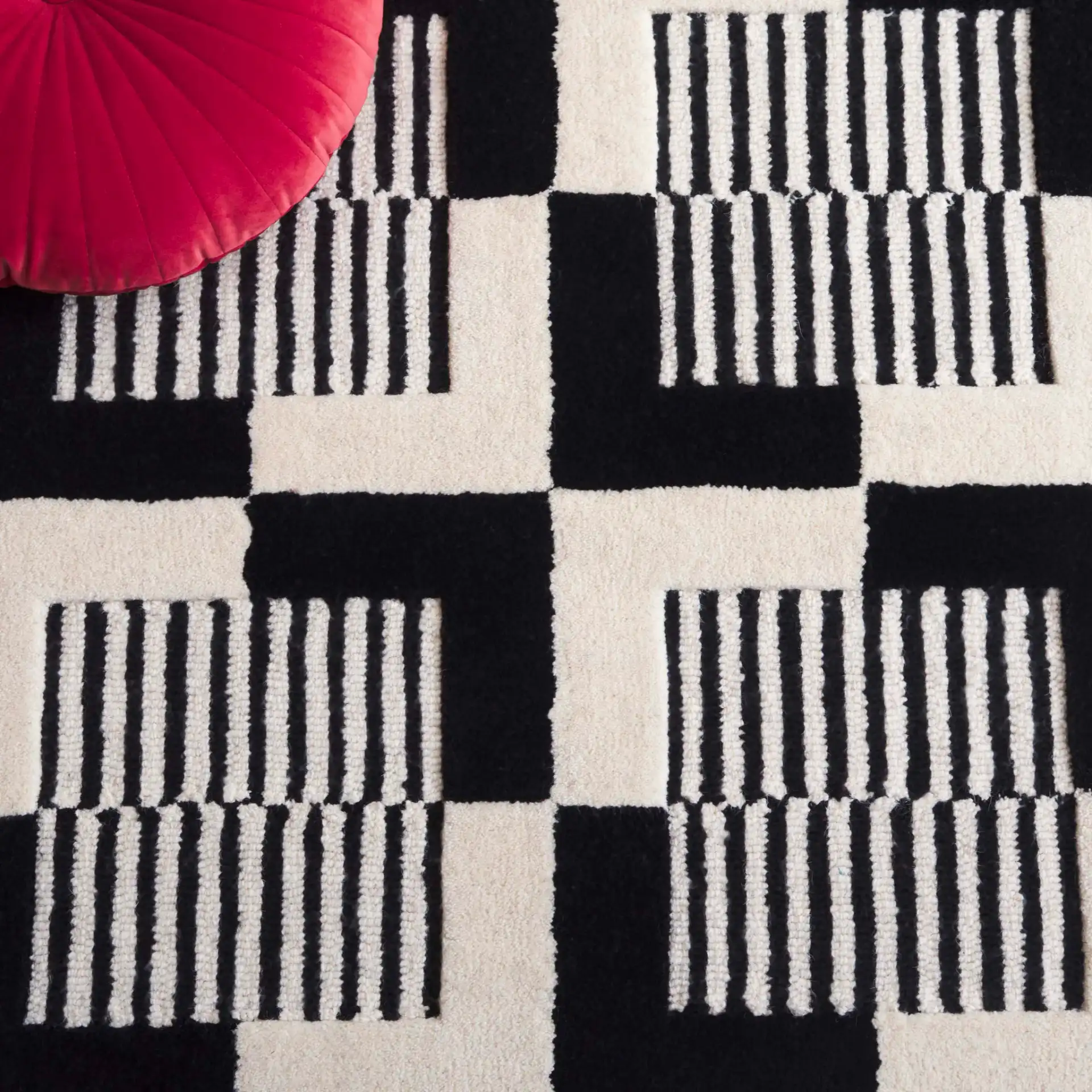 Metro Striped Checkerboard Hand-Tufted Wool Rug in Black / Ivory in a styled room