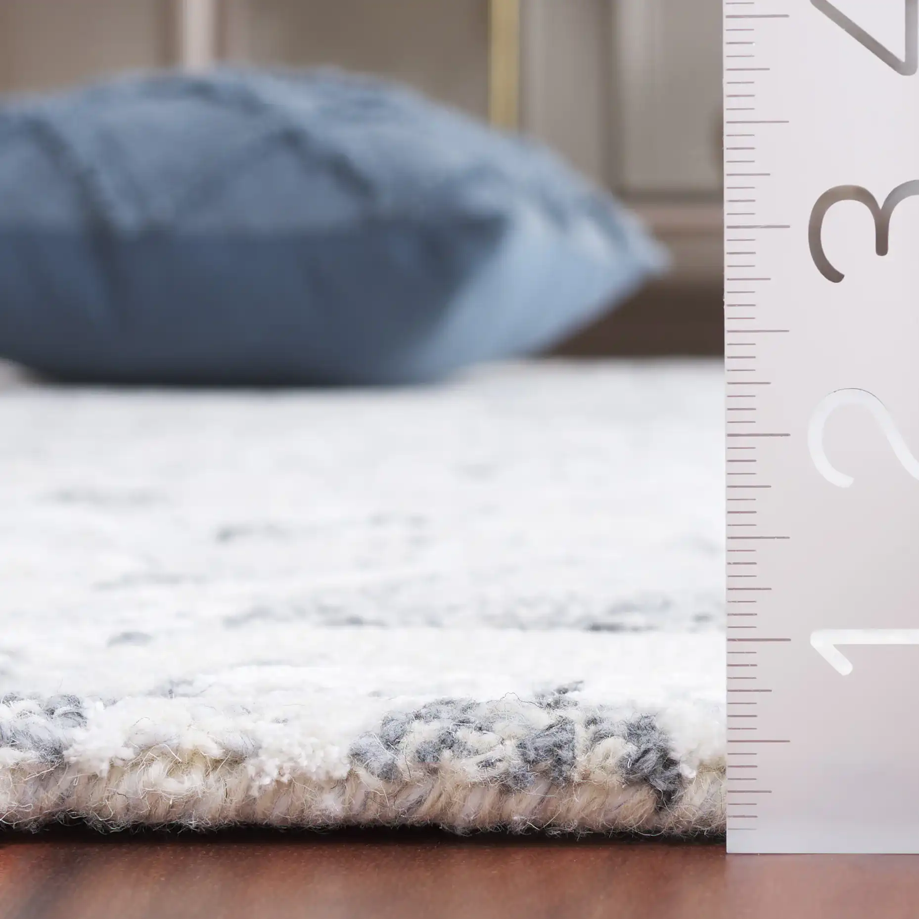 Metro Floral Scroll Hand-Tufted Wool Rug in Gray / Ivory in a styled room
