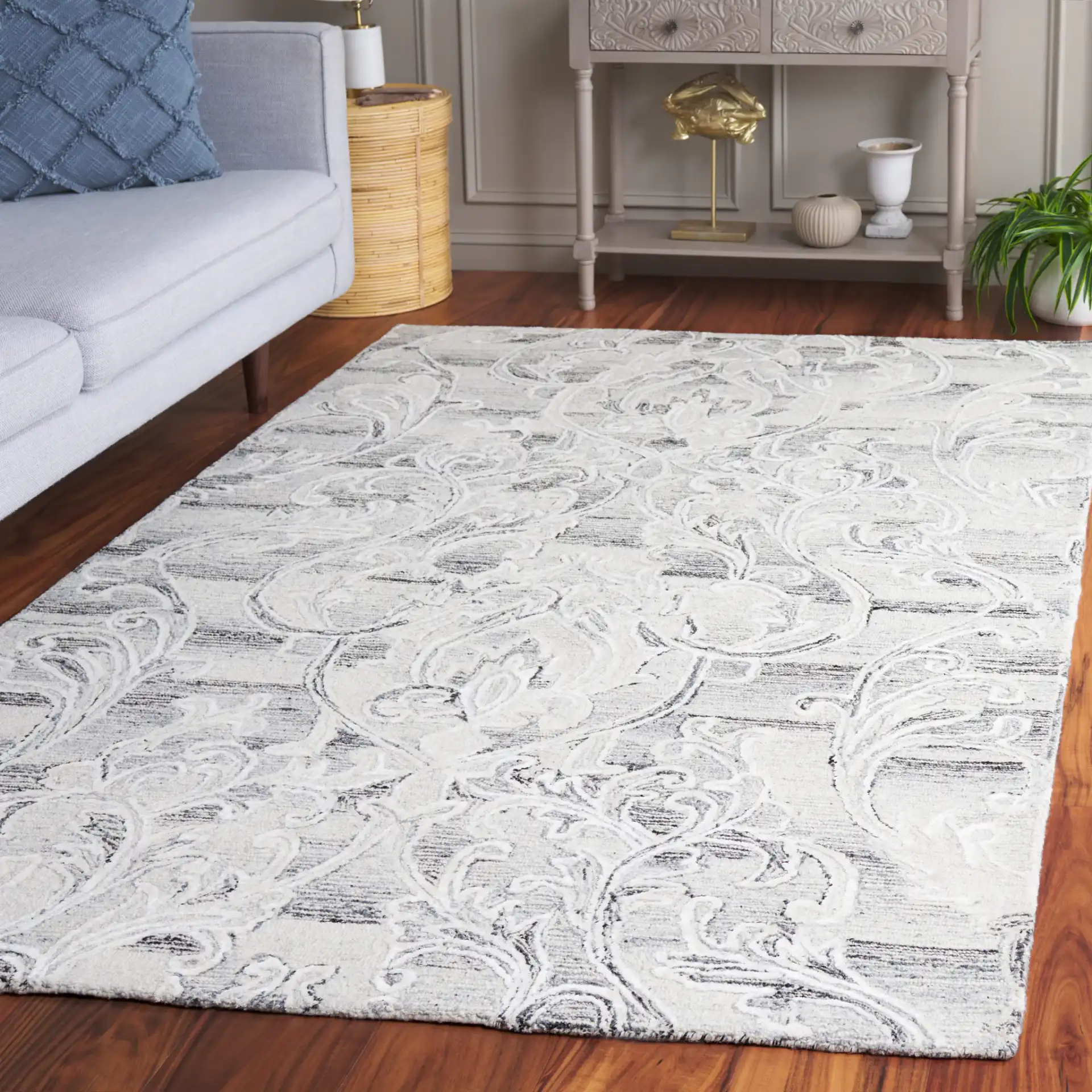 Metro Floral Scroll Hand-Tufted Wool Rug in Gray / Ivory in a styled room