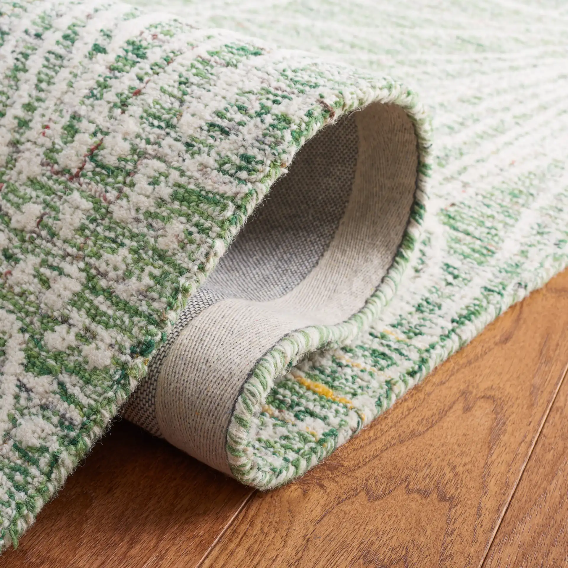 Metro Botanical Hand-Tufted Wool Rug in Green / Ivory in a styled room