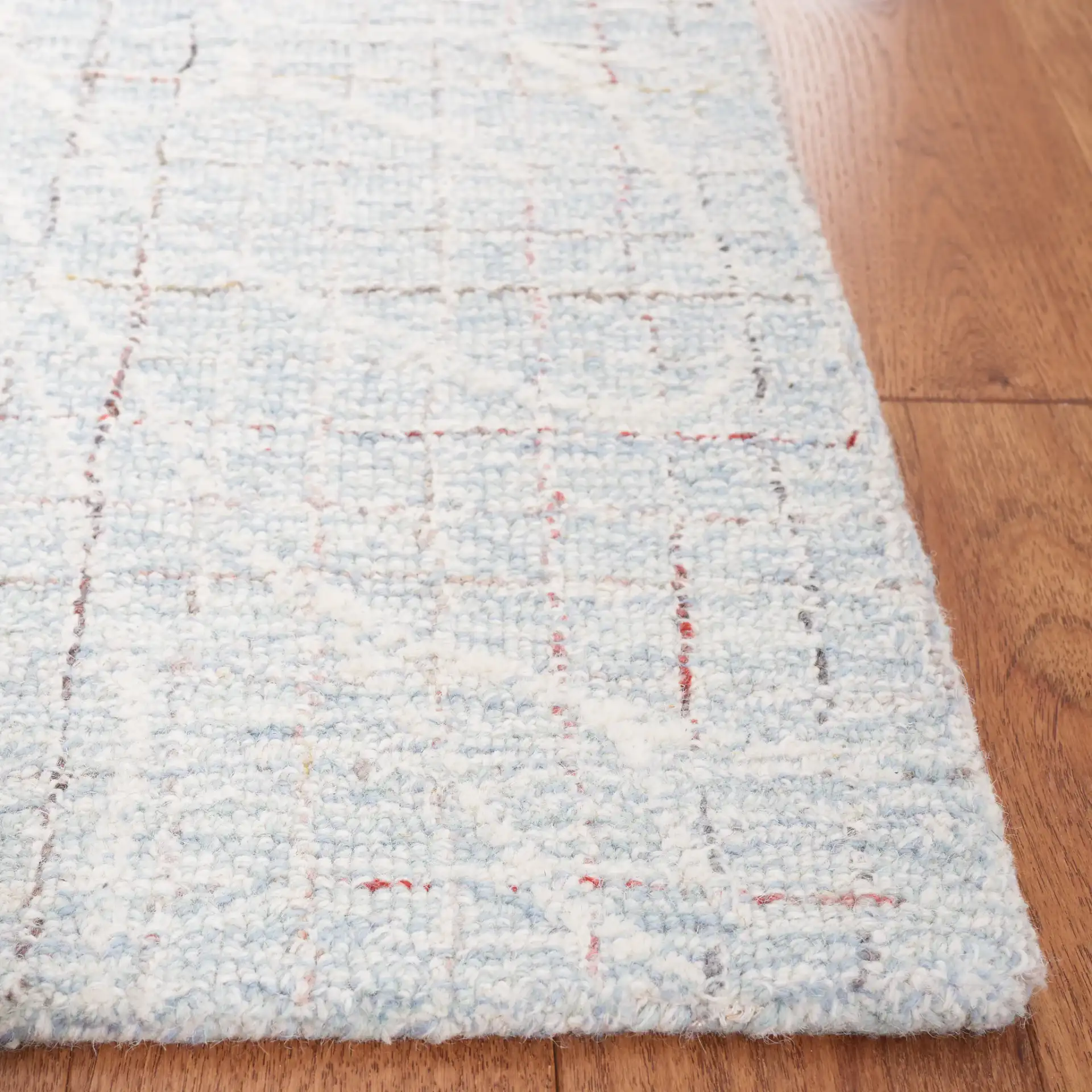 Metro Botanical Grid Hand-Tufted Wool Rug in Blue / Ivory in a styled room