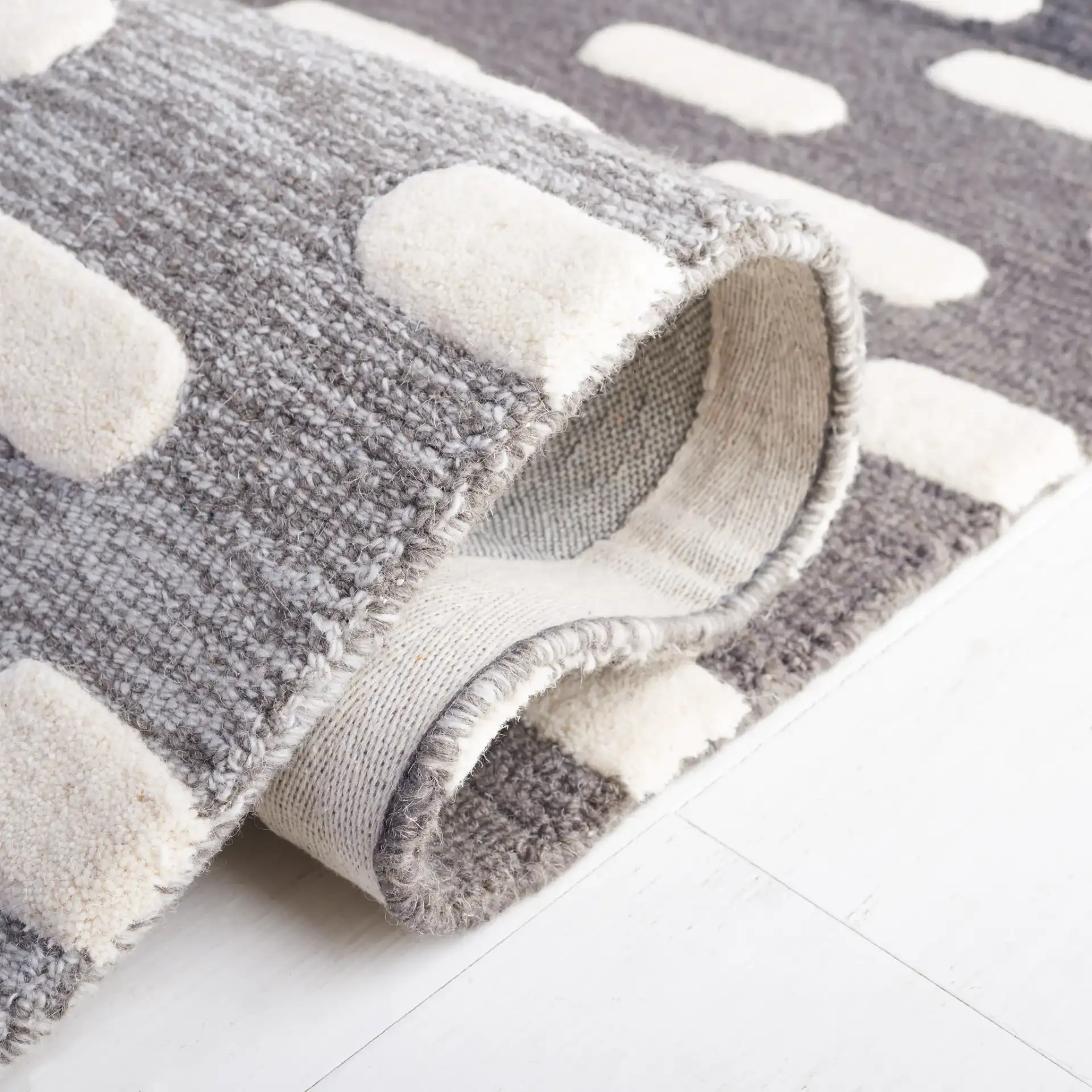 Metro Gradient Dash Hand-Tufted Wool Rug in Black / Ivory in a styled room